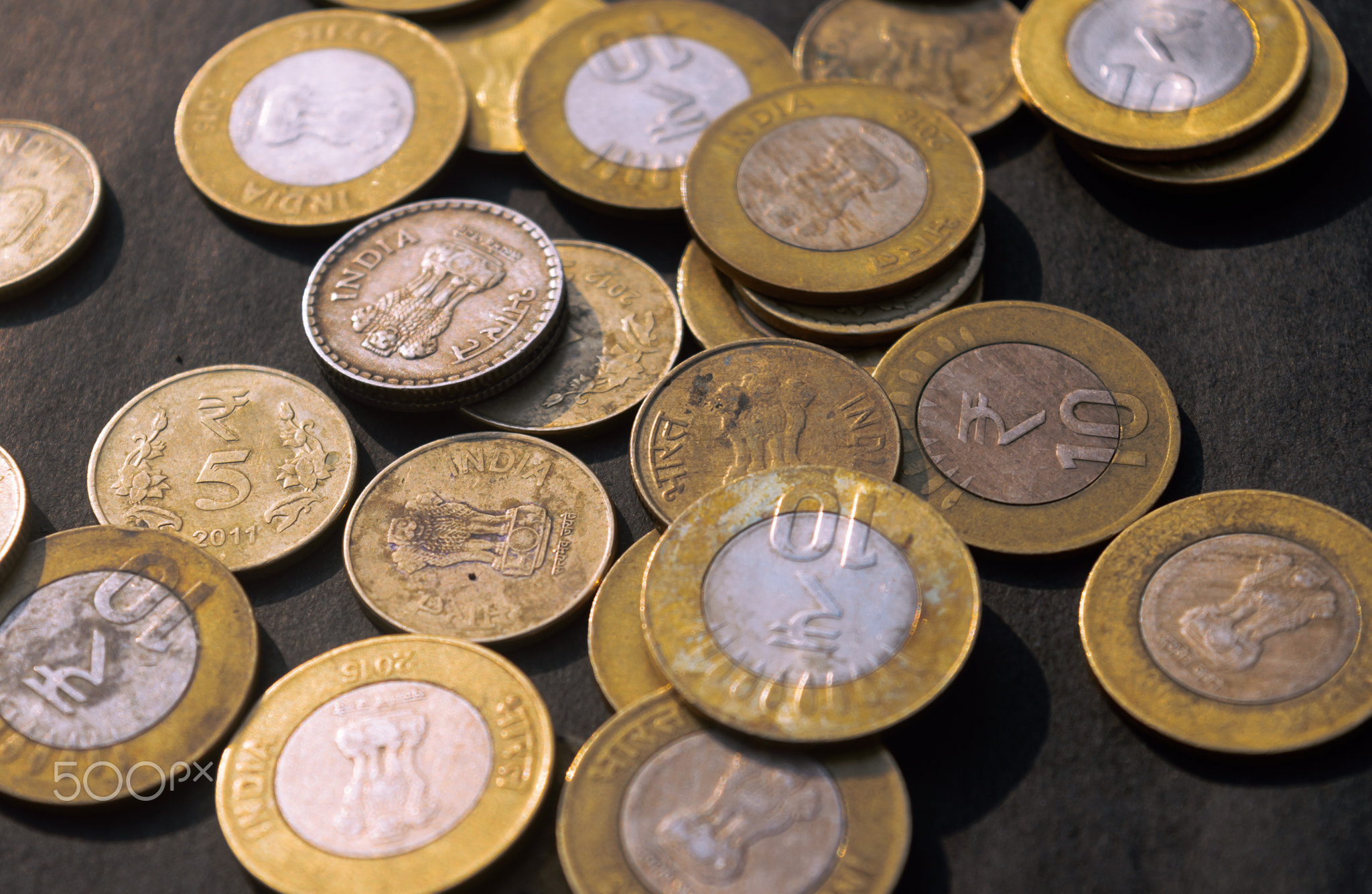 Indian Rupee Coin currency on rustic floor. Full Frame.