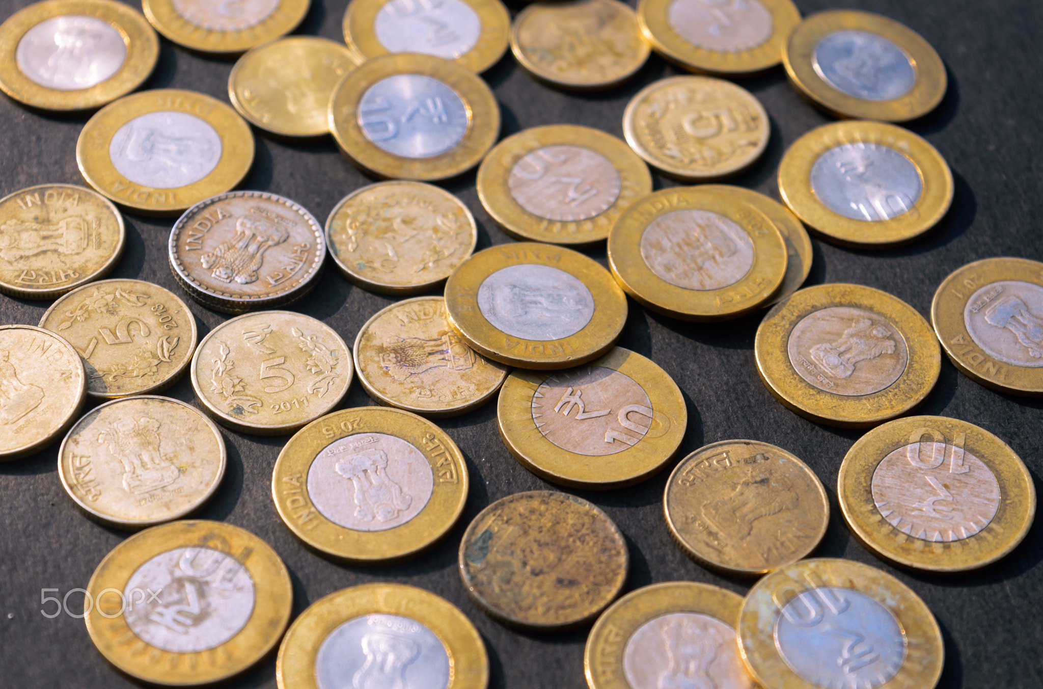 Indian Rupee Coin currency on rustic floor. Full Frame.