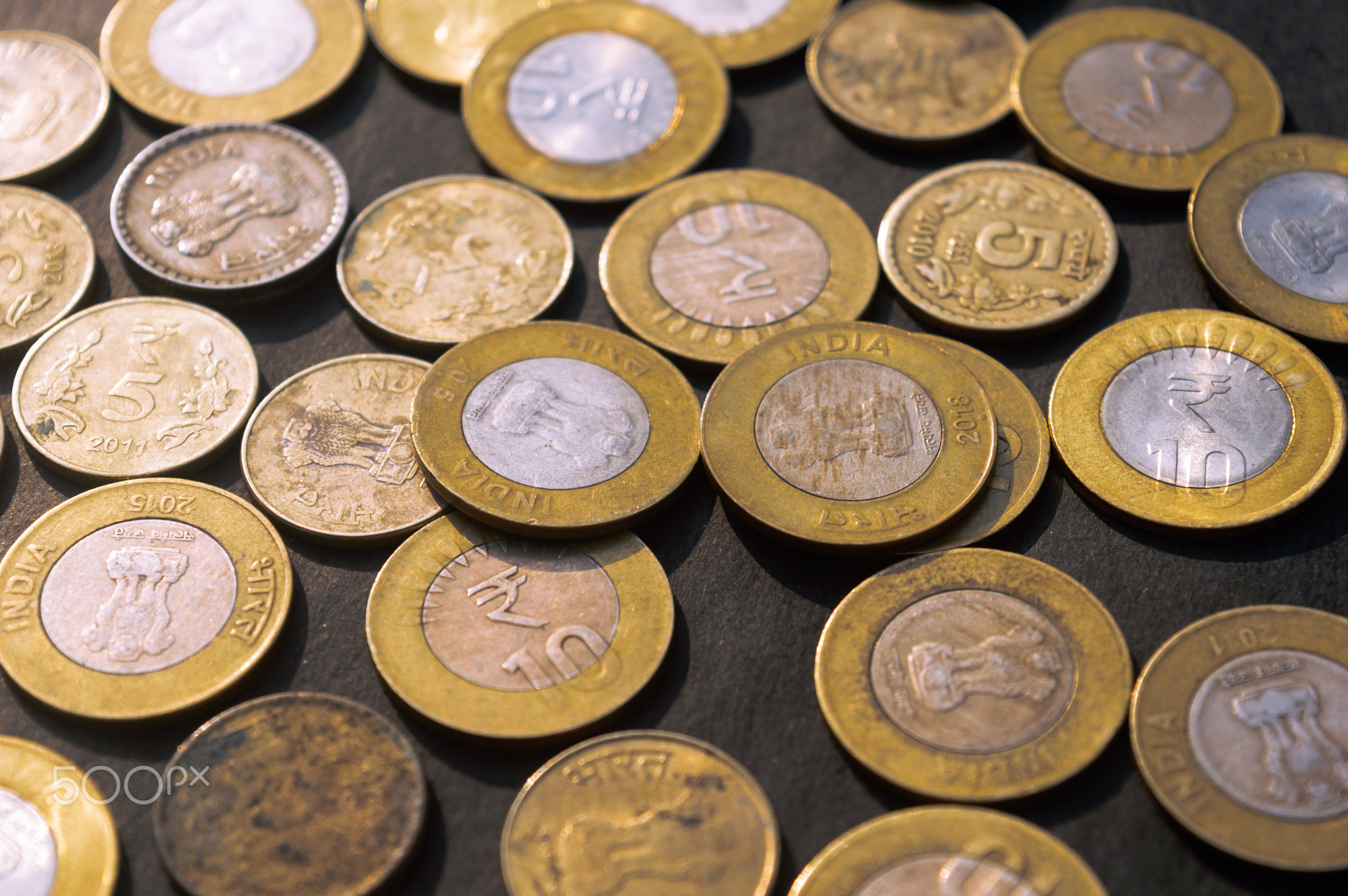 Indian Rupee Coin currency on rustic floor. Full Frame.