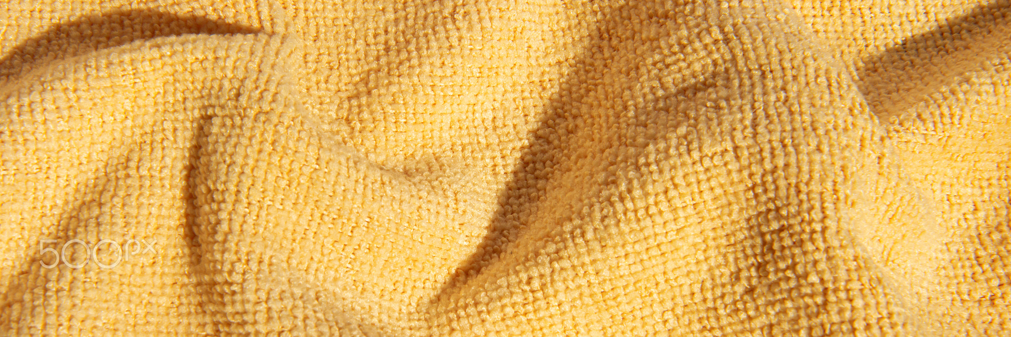 Bright, yellow, fluffy, light blanket. Texture textile background