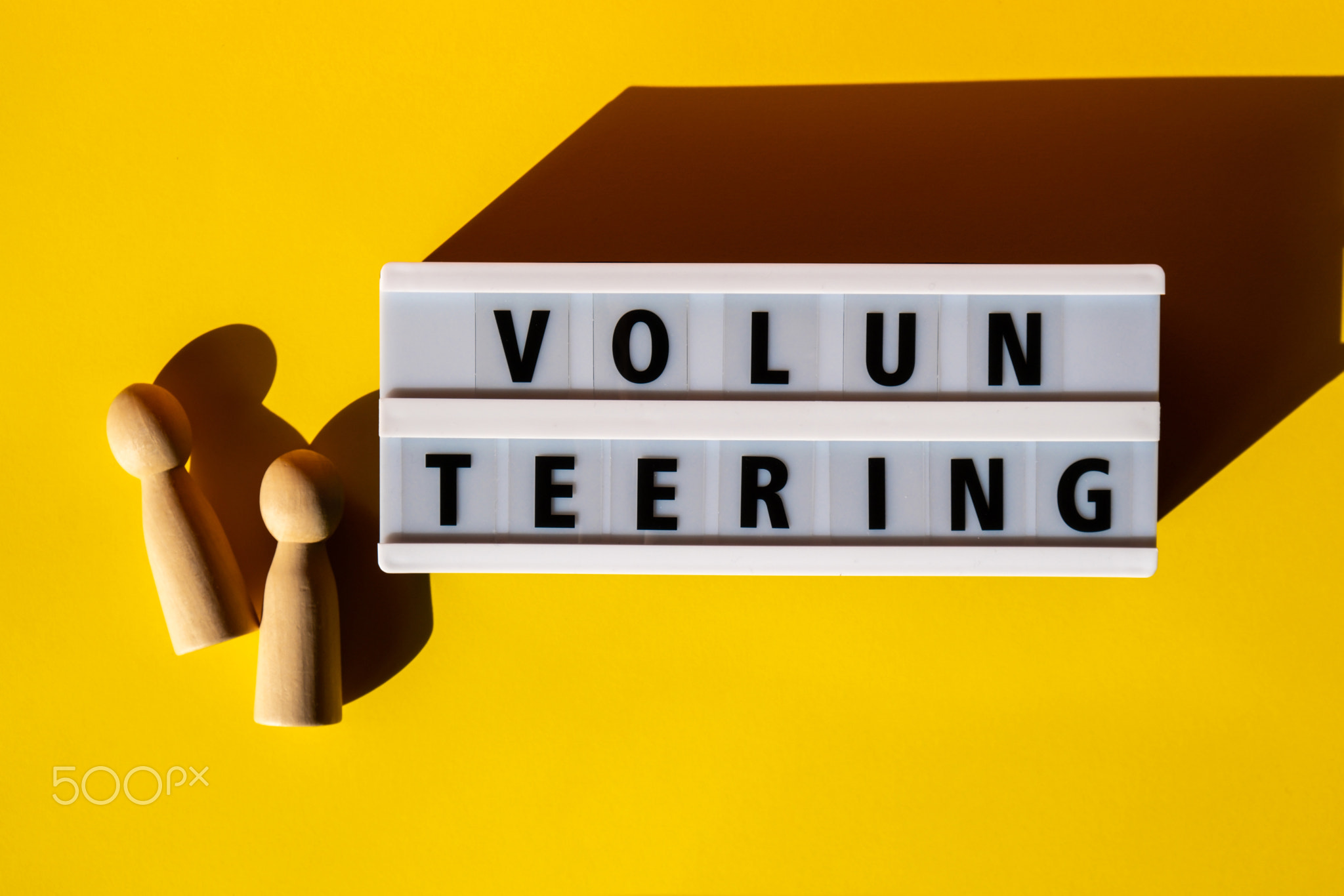 Lightbox with text VOLUNTEERING. Motivational Words Quotes Concept
