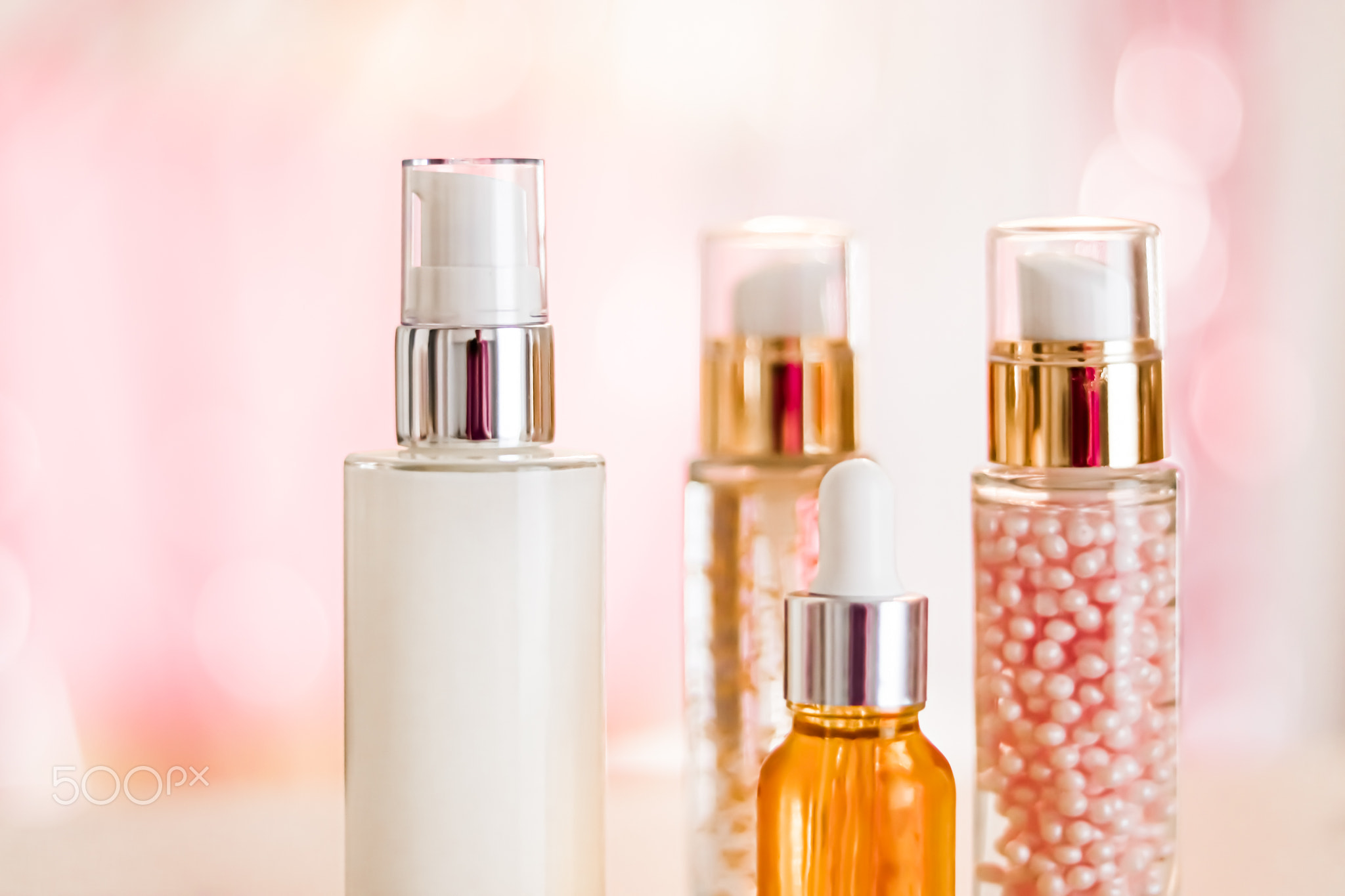 Skincare cosmetics products on glamour background, glass bottles with