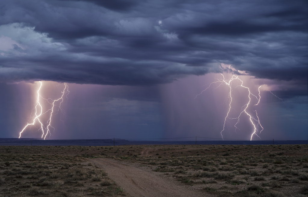 Twin Rain Shafts and Lightning Bolts Down the Road by Fred Walder / 500px