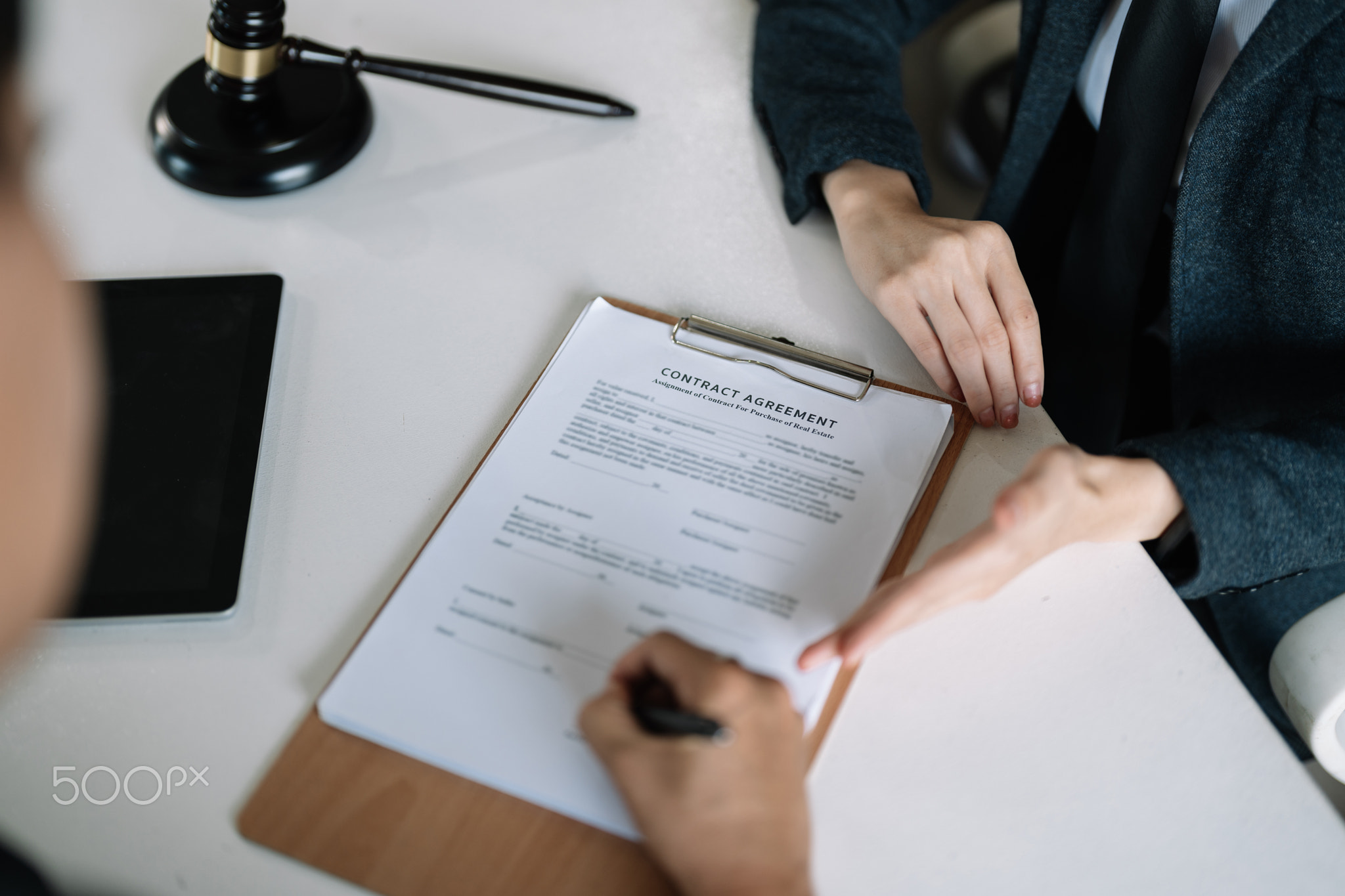 Lawyer Legal counsel presents to the client a signed contract with