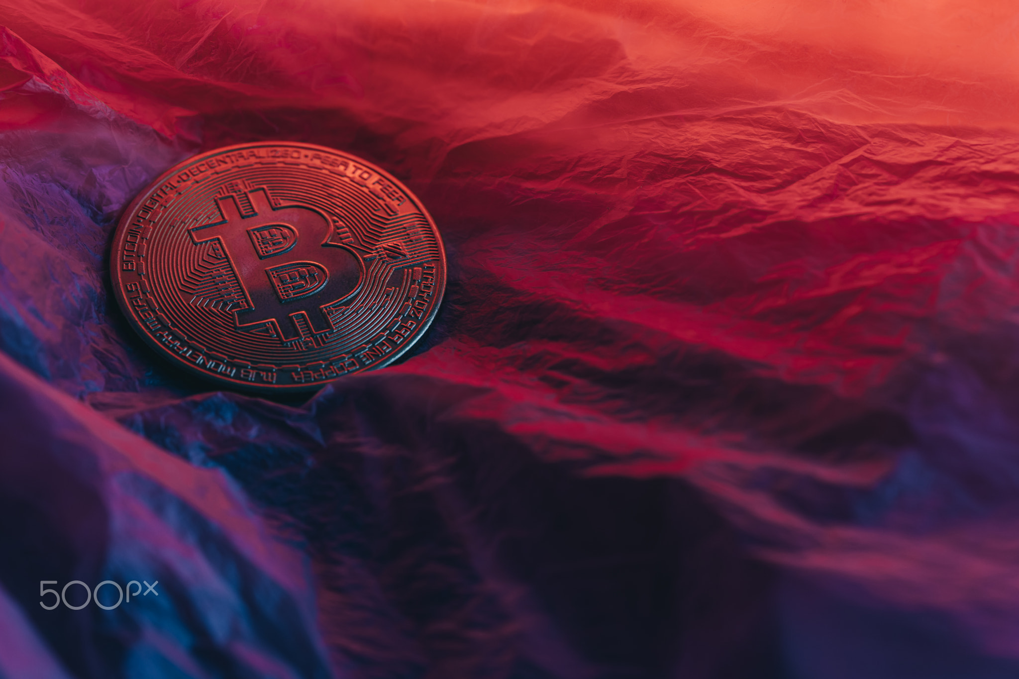 Bitcoin on neon surface. Photo for presentation.