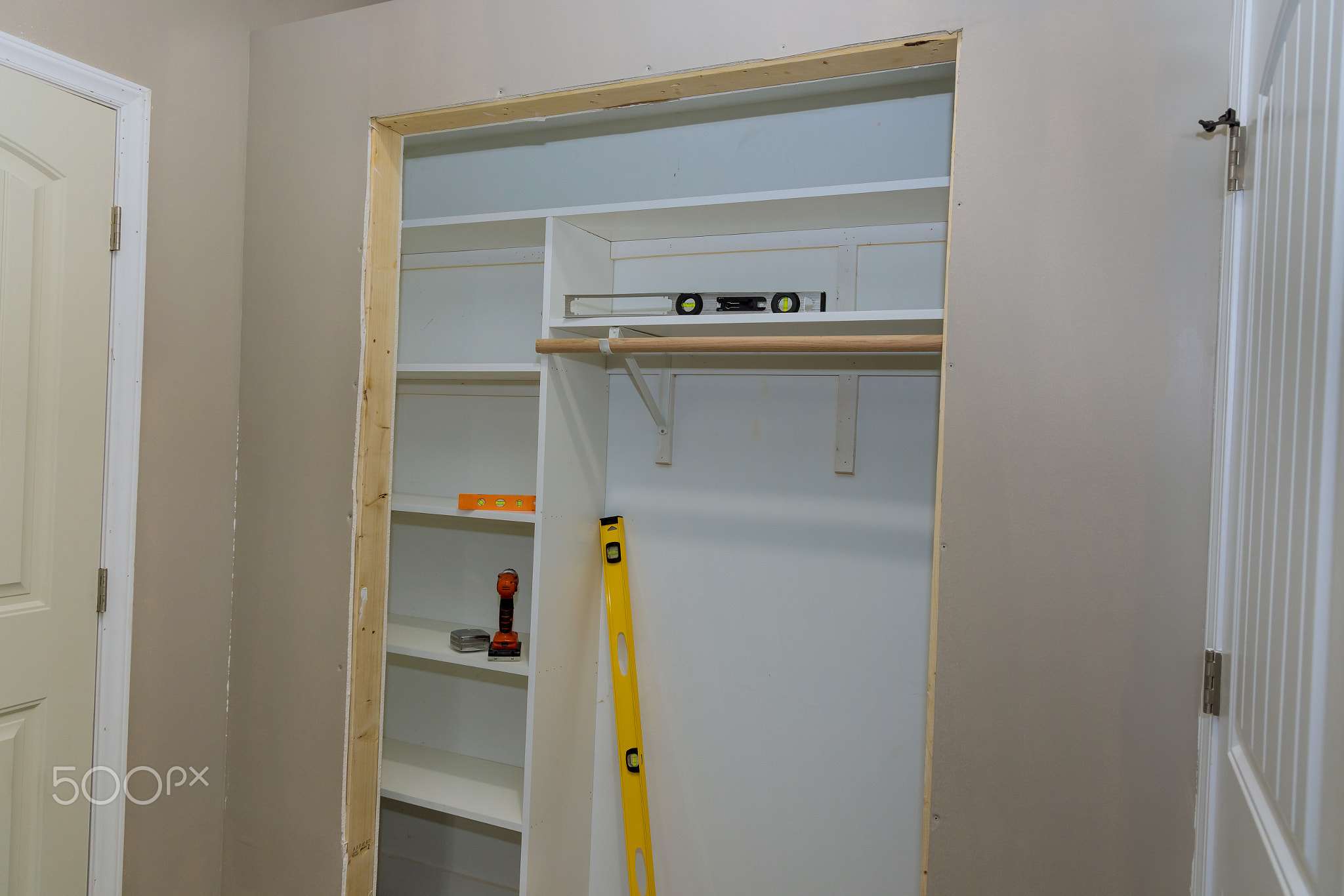 There are many empty shelves for space to be used to store clothes on