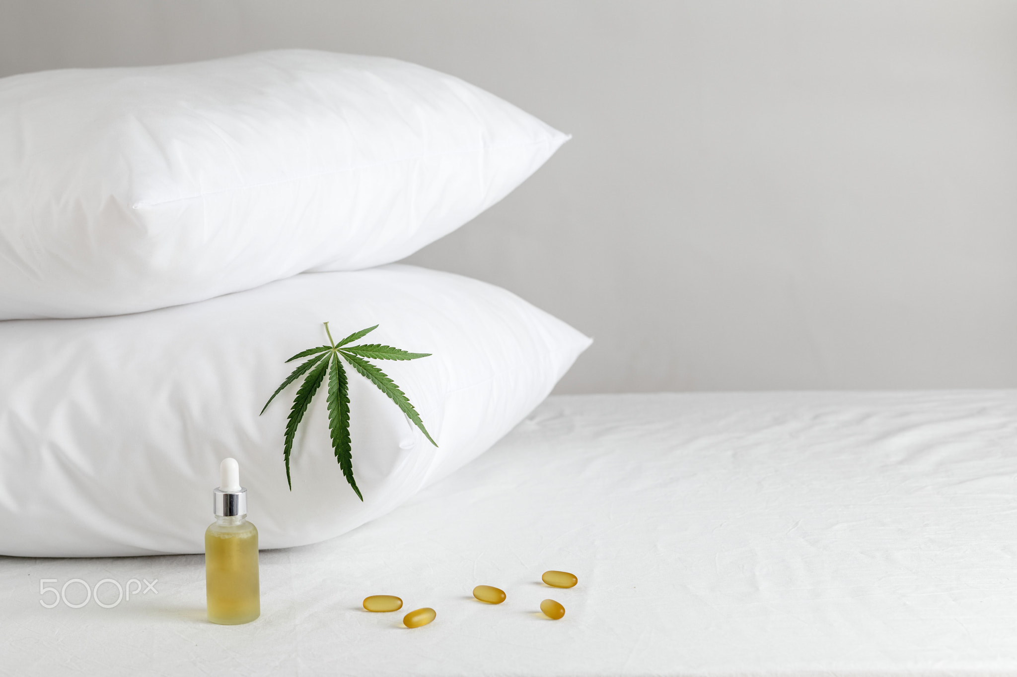 Melotonin production, pills, capsules and cbd oil on the bed. Concept