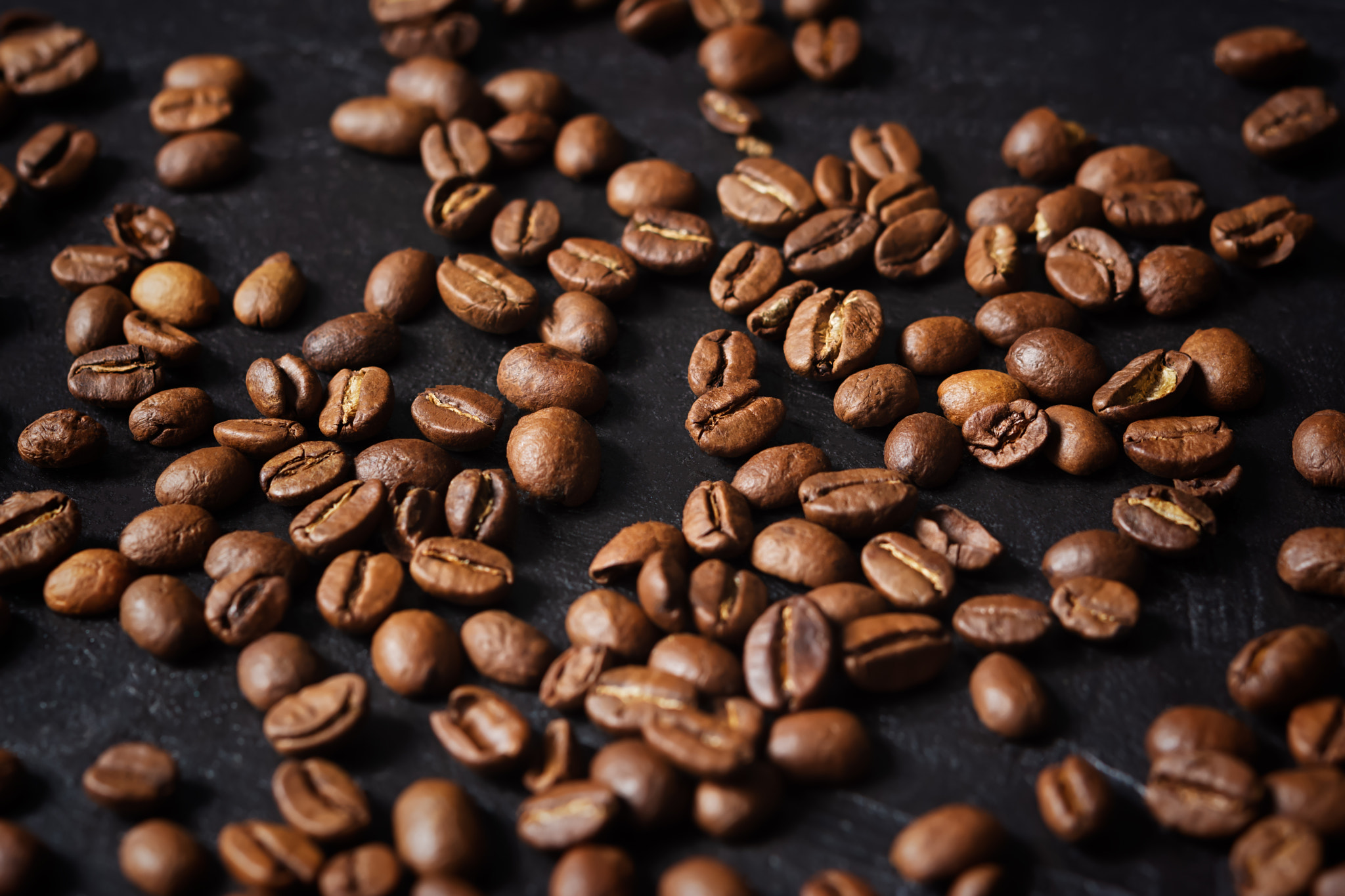 Coffee grain black background top view.