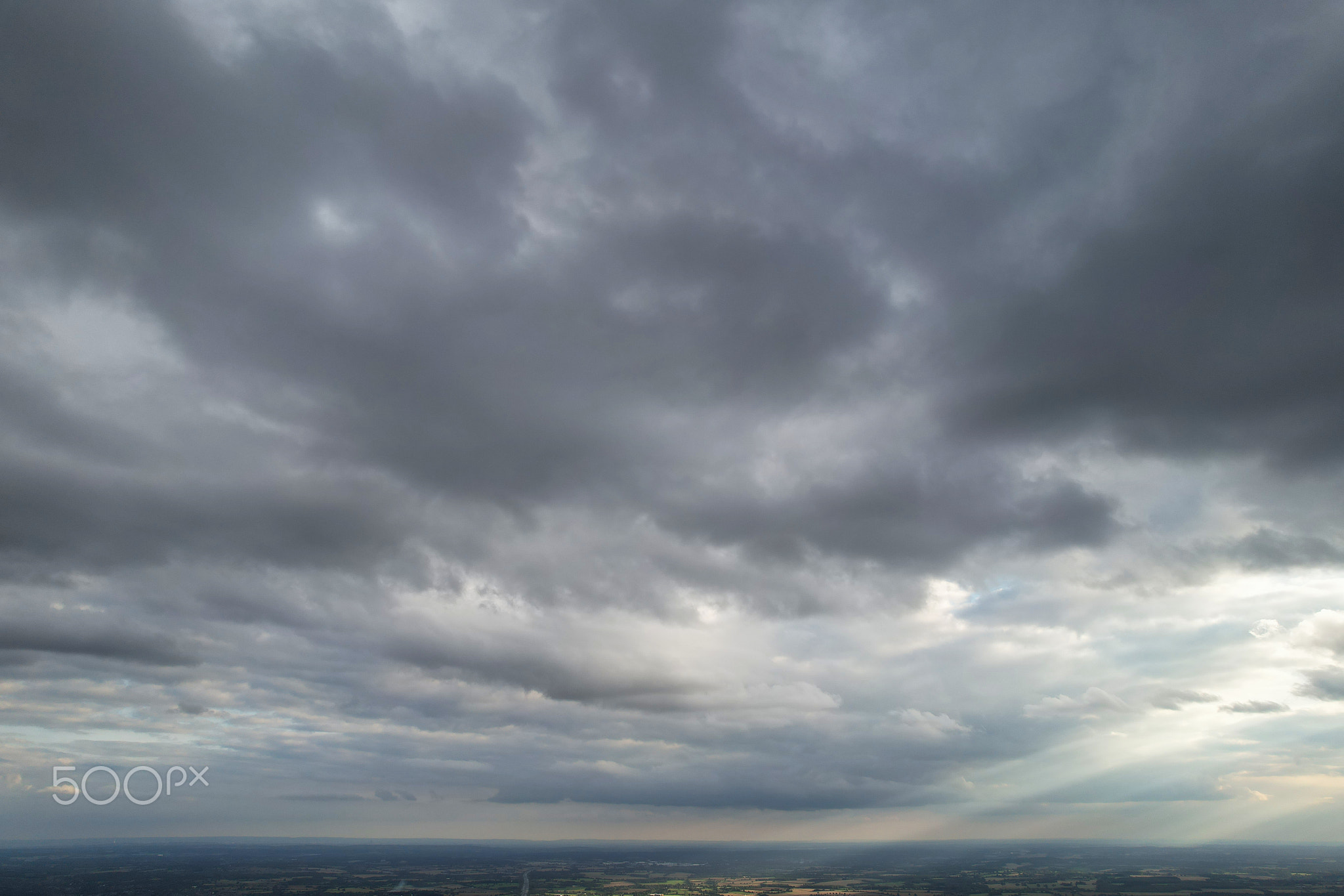 Scenic view of storm clouds over landscape