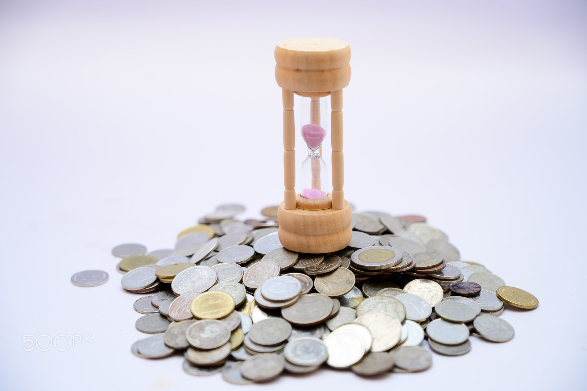 Hourglass and coin time concept and money saving