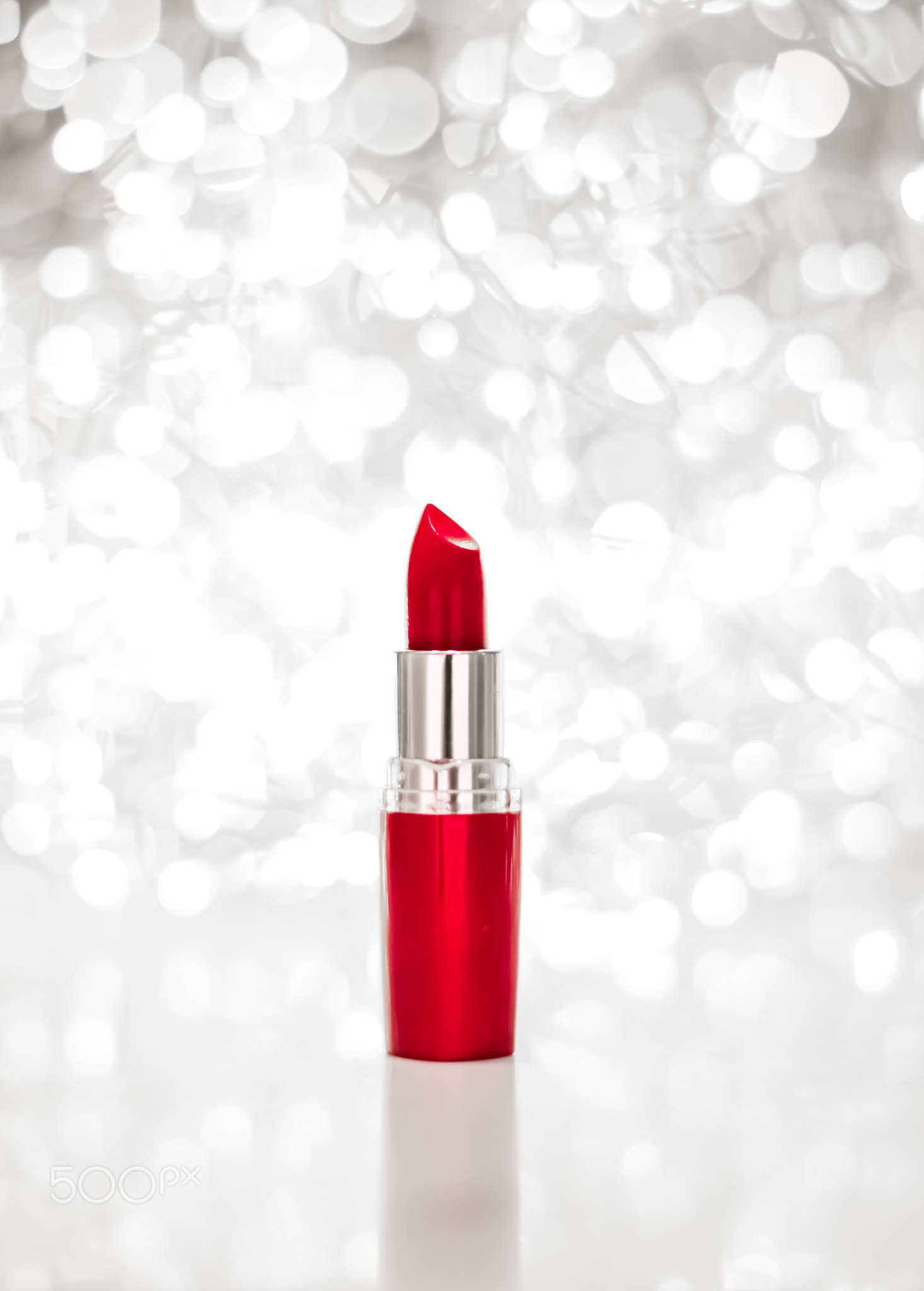 Red lipstick on silver Christmas, New Years and Valentines Day holiday