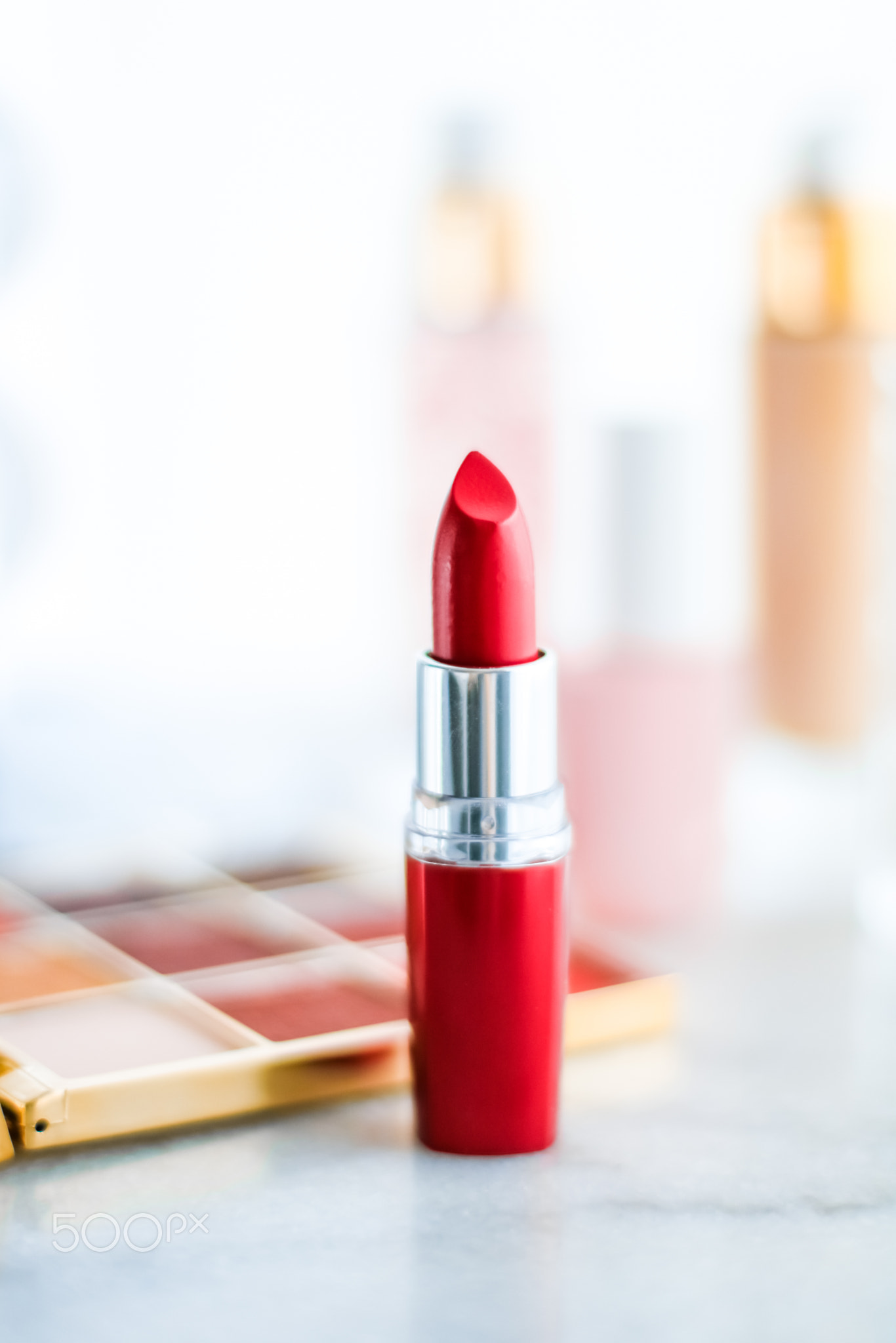 Cosmetics, makeup products on dressing vanity table, lipstick
