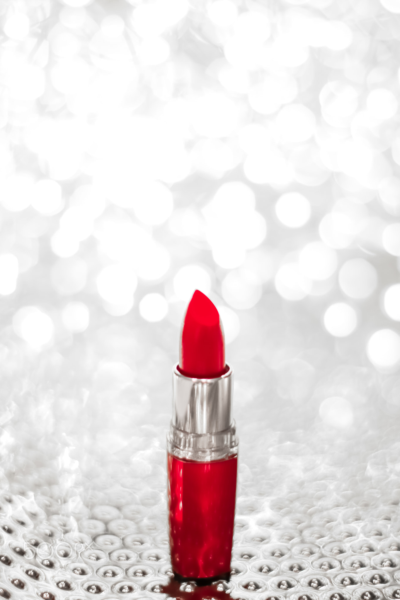 Red lipstick on silver Christmas, New Years and Valentines Day holiday