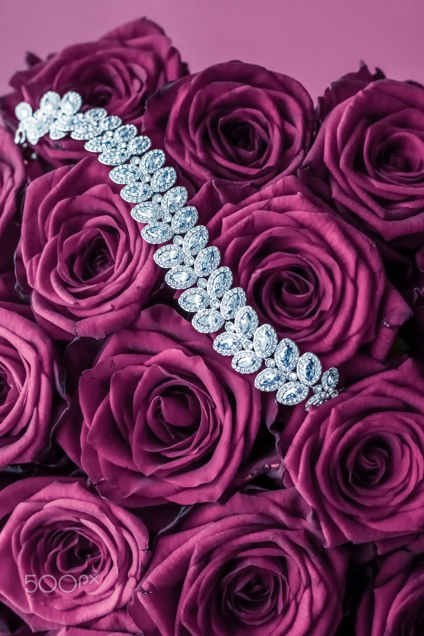 Luxury diamond jewelry bracelet and pink roses flowers, love gift on