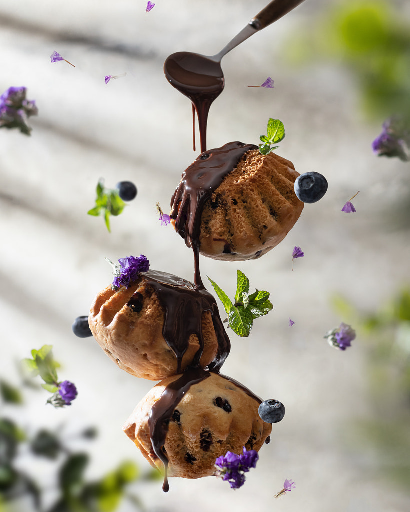 Delisious raisins muffins in levitaion with chocolate and berries by Hanna Hafarava on 500px.com