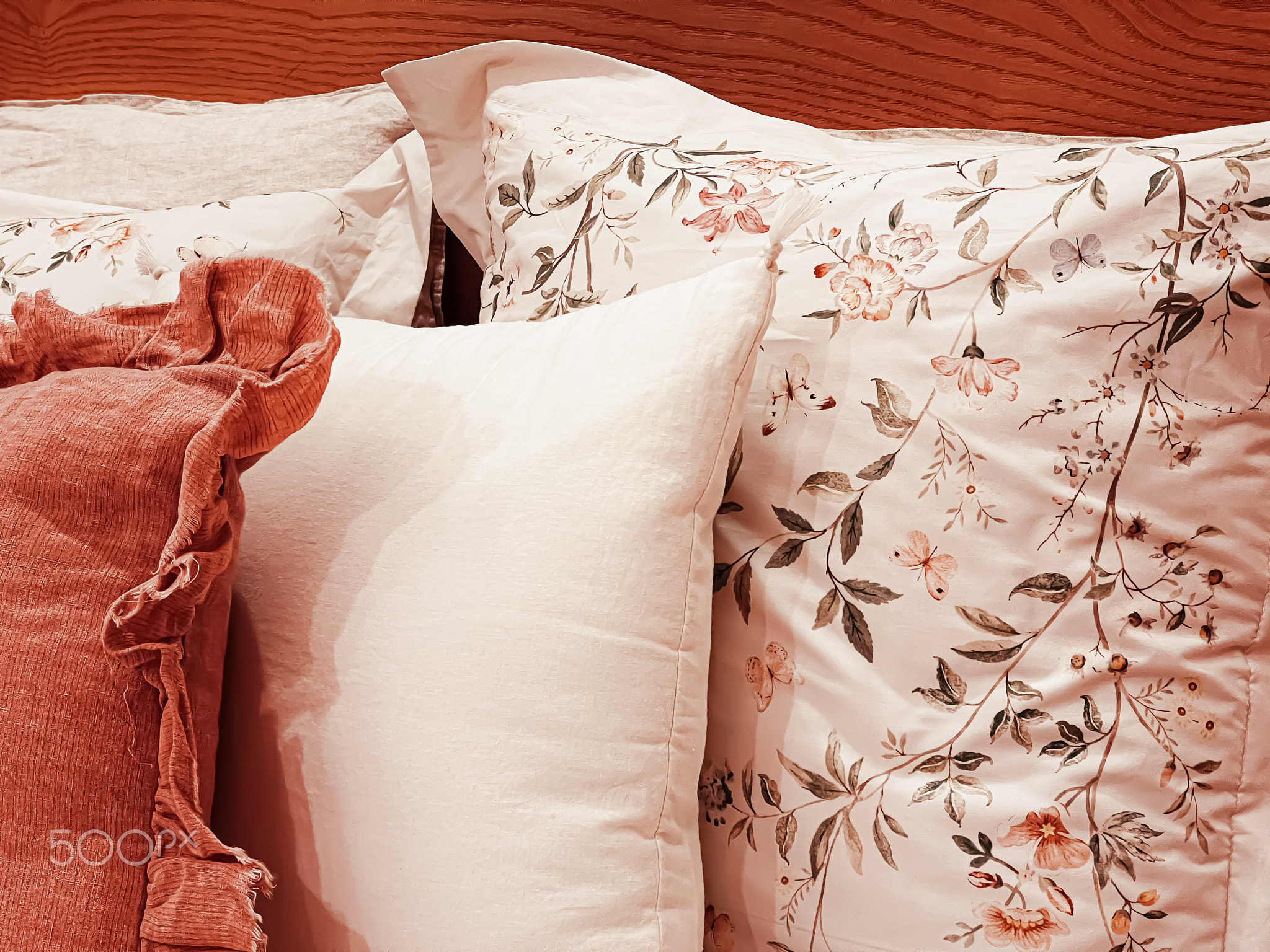 Vintage countryside style bedding with floral pattern on wooden bed in