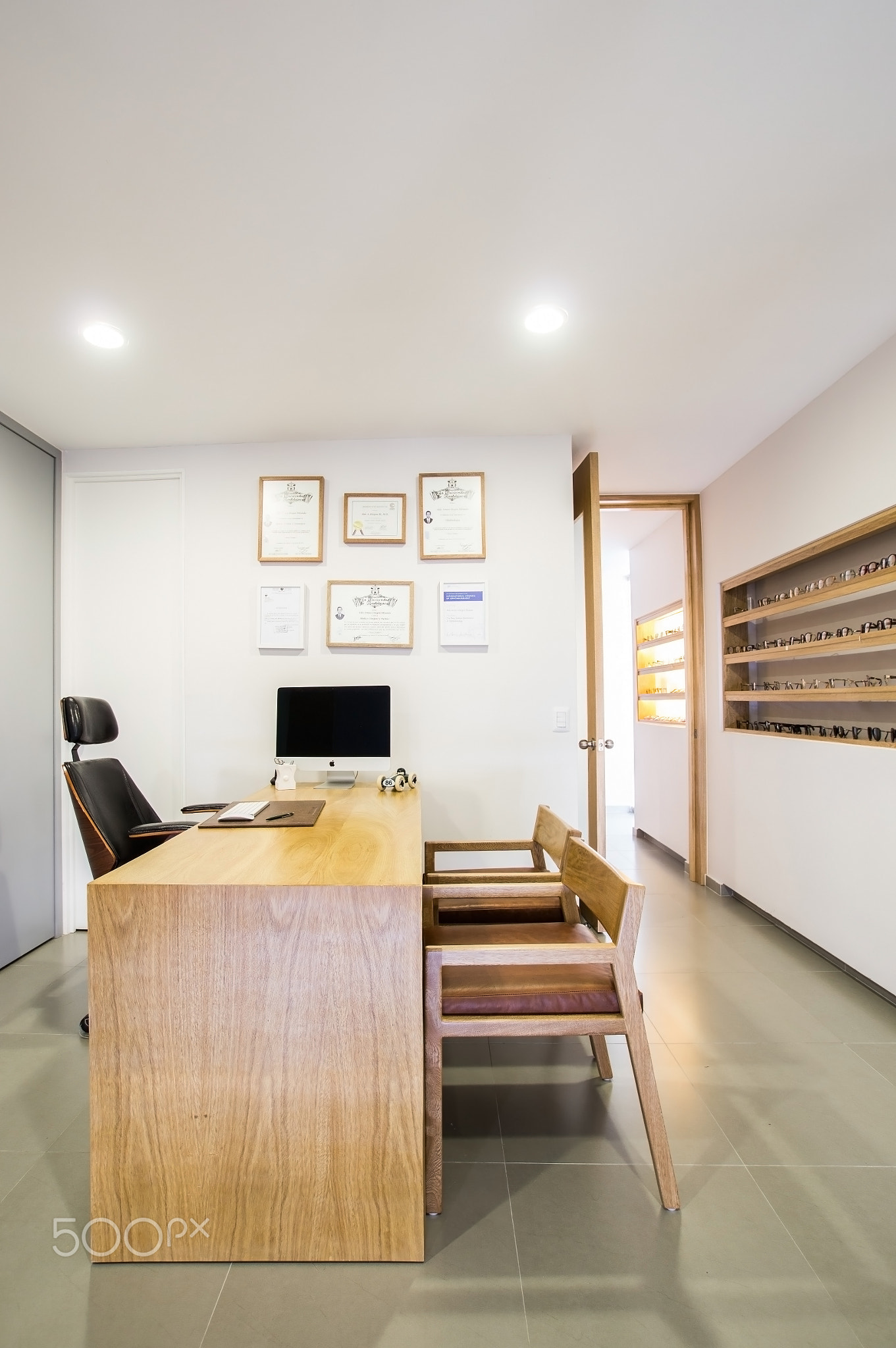 ophthalmologist's office wooden consulting room with computer on the desk,