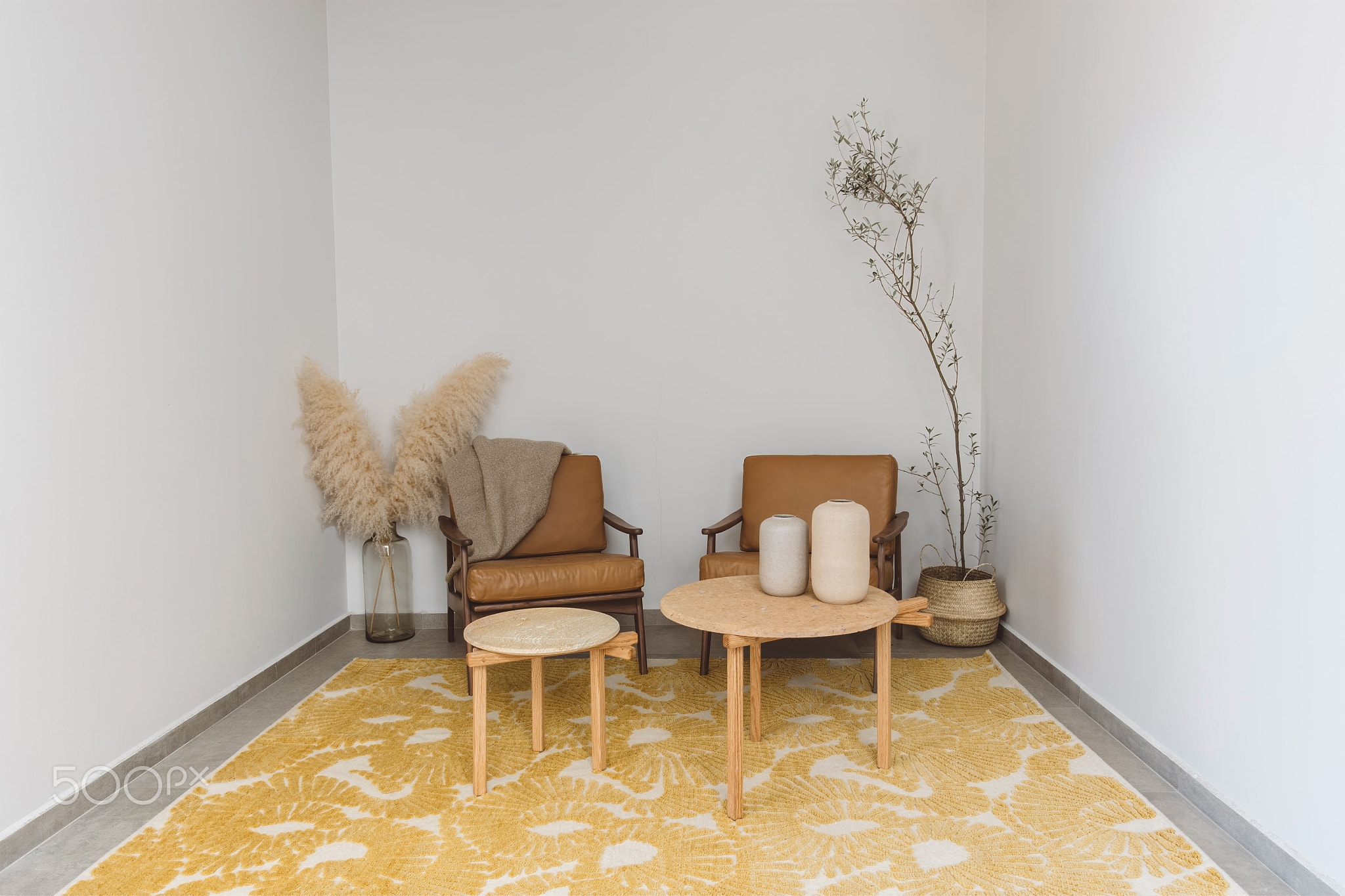 scandinavian room interior design, with designer armchairs and natural leather style