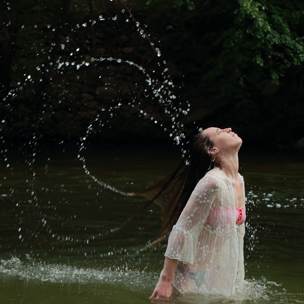 side-view-of-woman-splashing-water-in-lake-by-bruno-vilb-500px