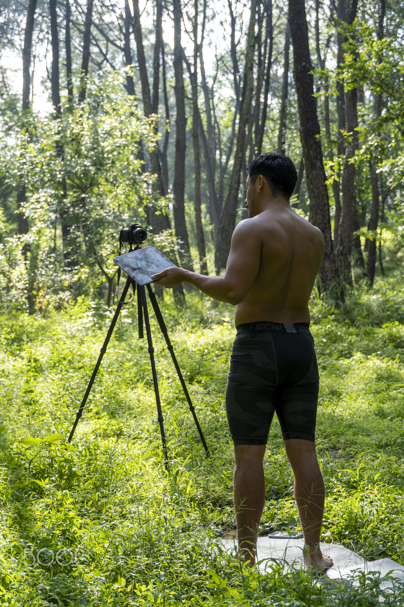 Guy with tablet making video blog on phone. Isolated person giving