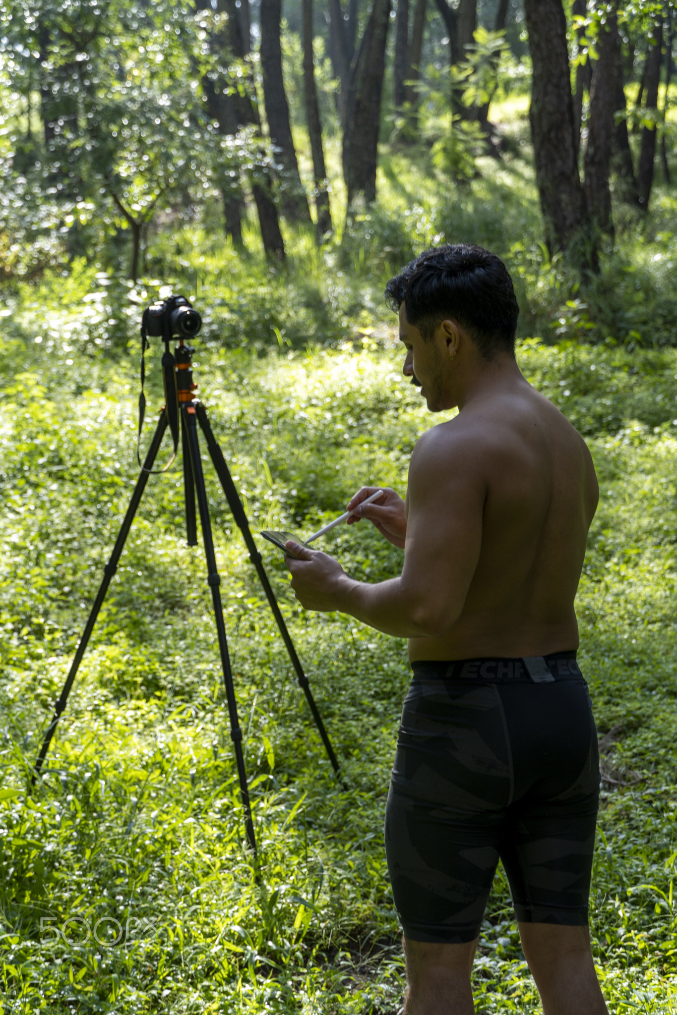 Guy with tablet making video blog on phone. Isolated person giving