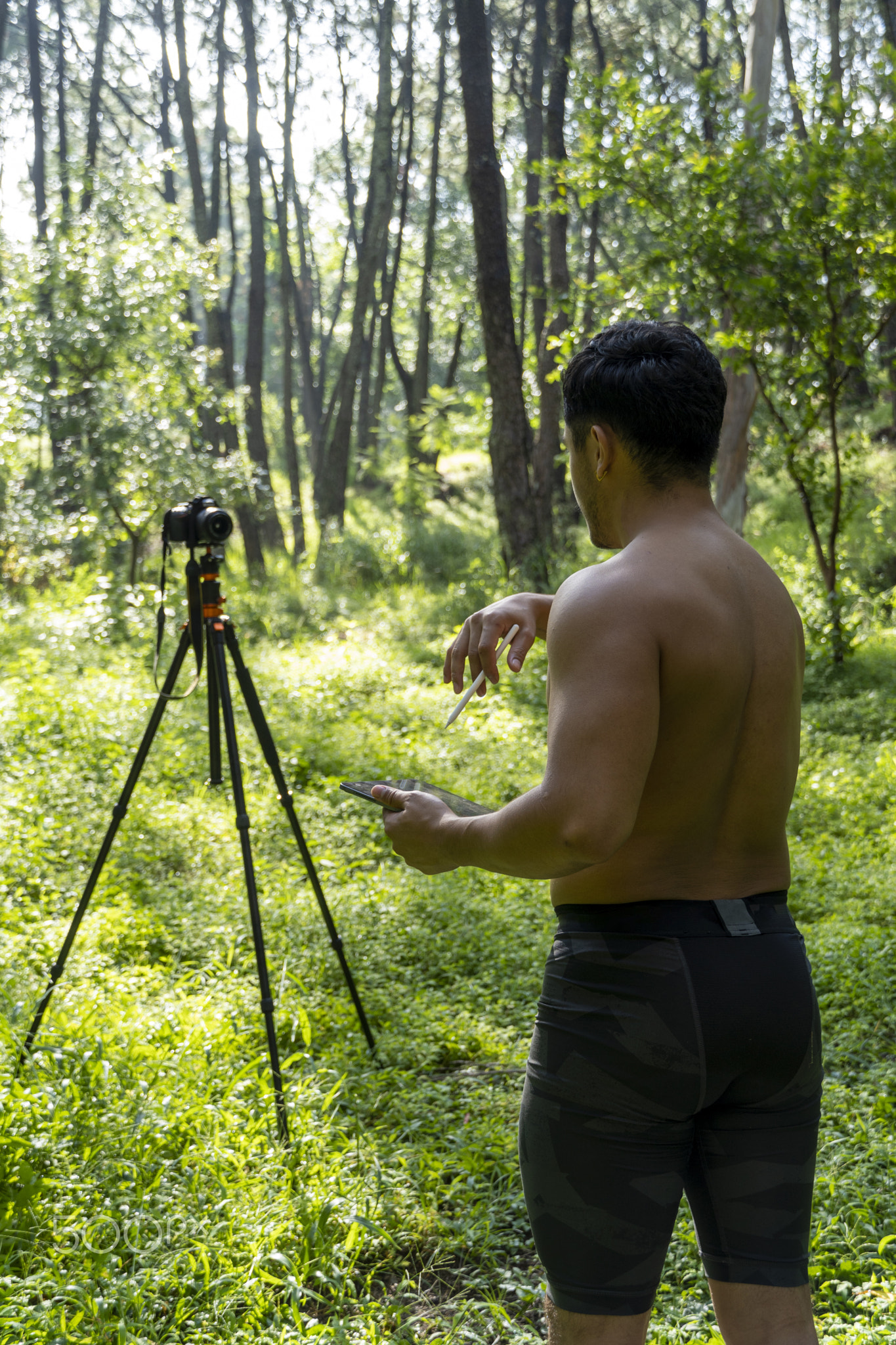 Guy with tablet making video blog on phone. Isolated person giving