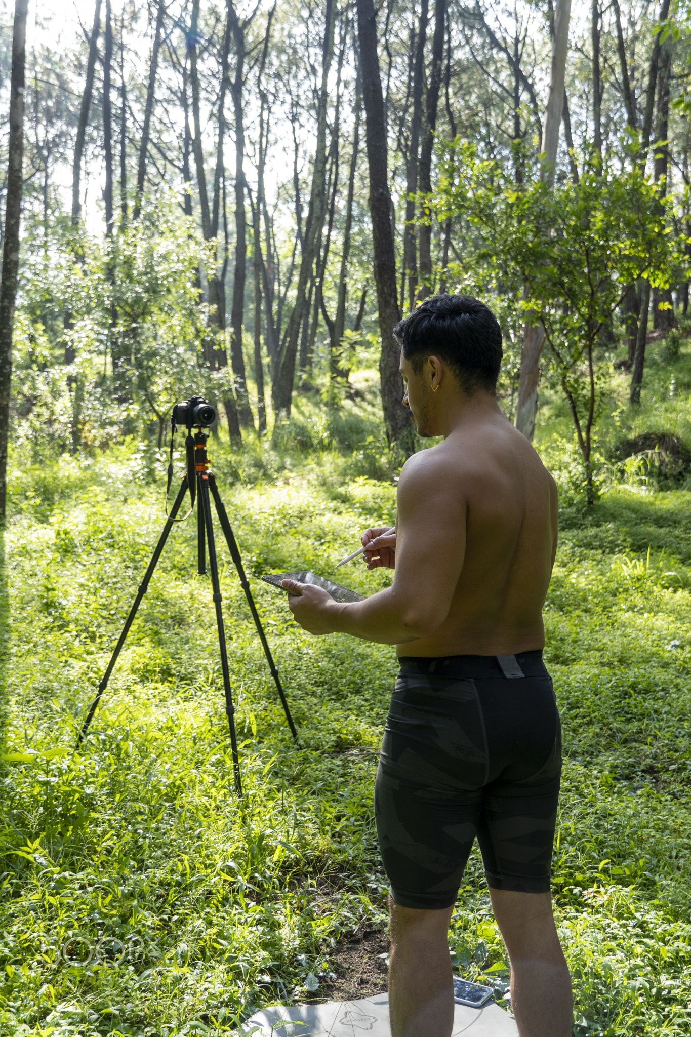 Guy with tablet making video blog on phone. Isolated person giving