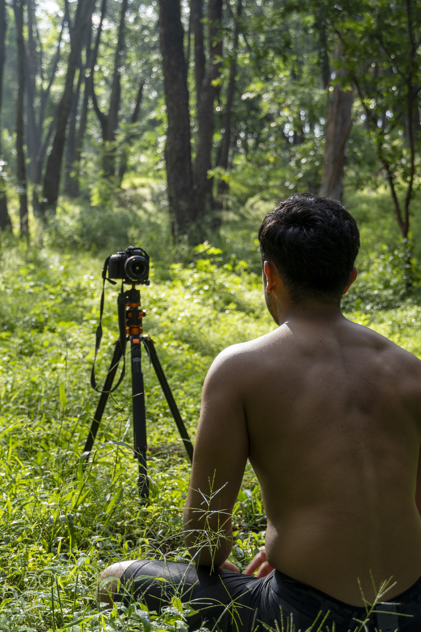 Millennial guy meditating with trainer online via tablet ipad