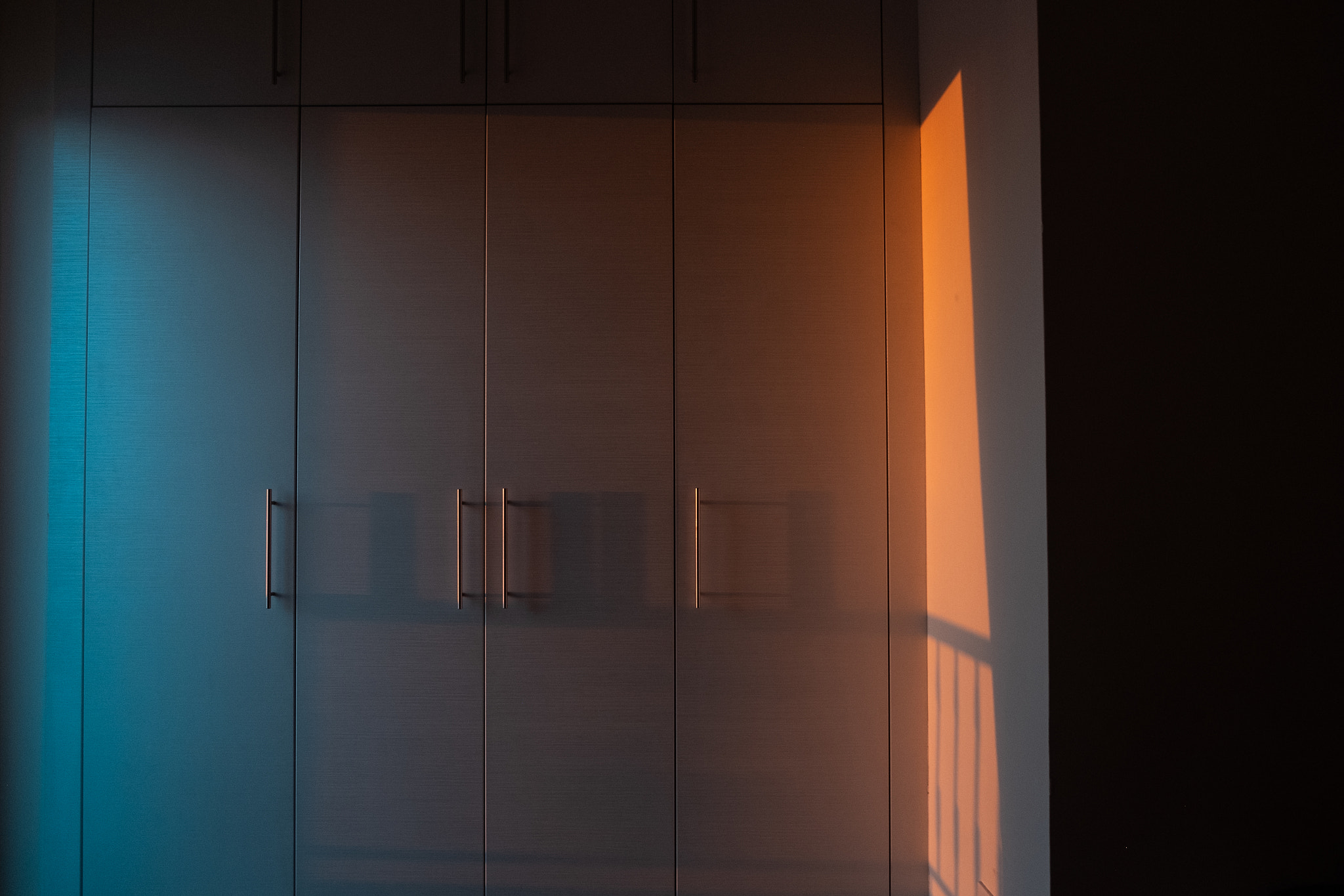 Contemporary white wardrobe illuminated by the sunrays