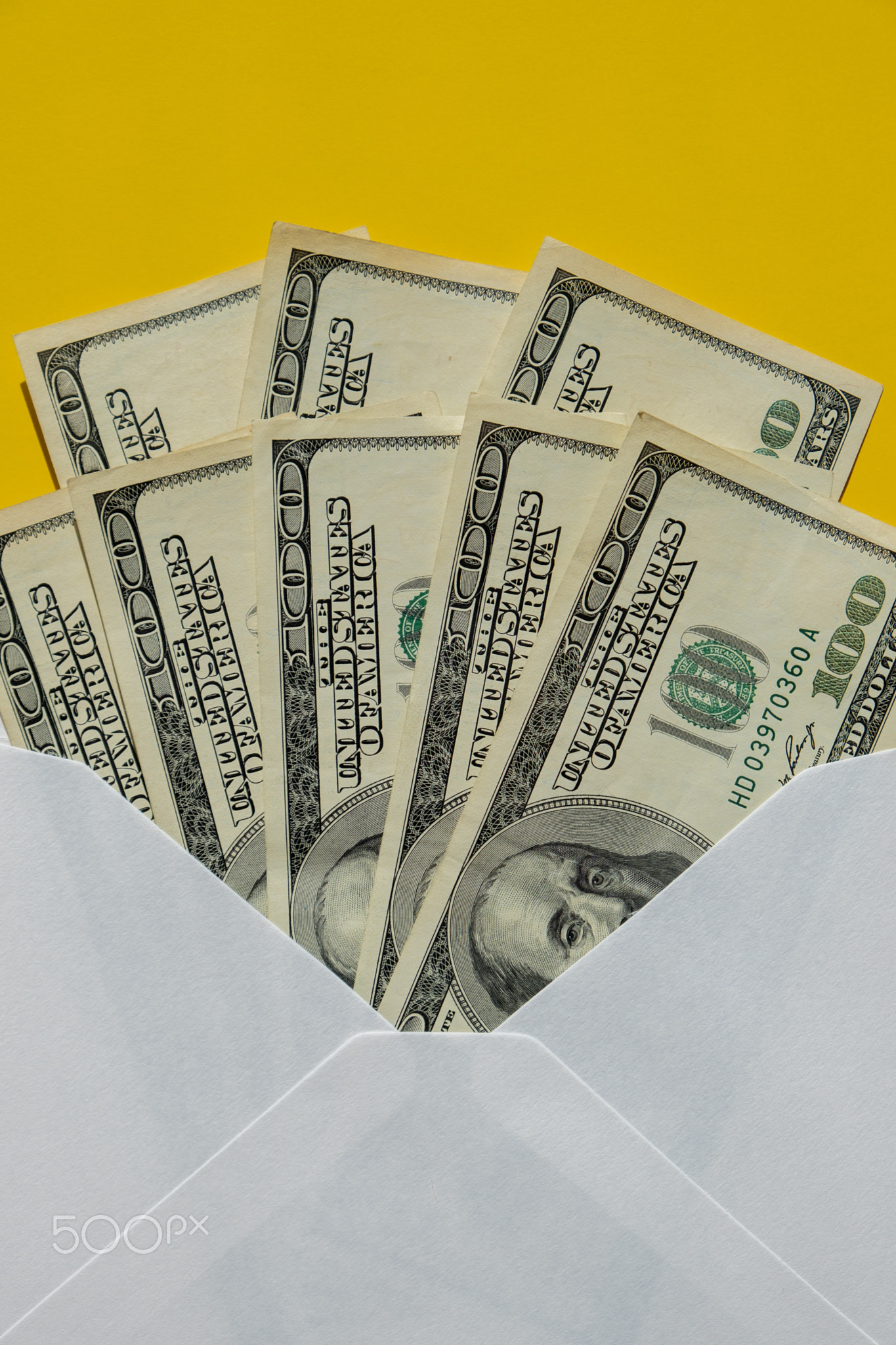 Dollar banknote saving money in envelope on yellow background copy