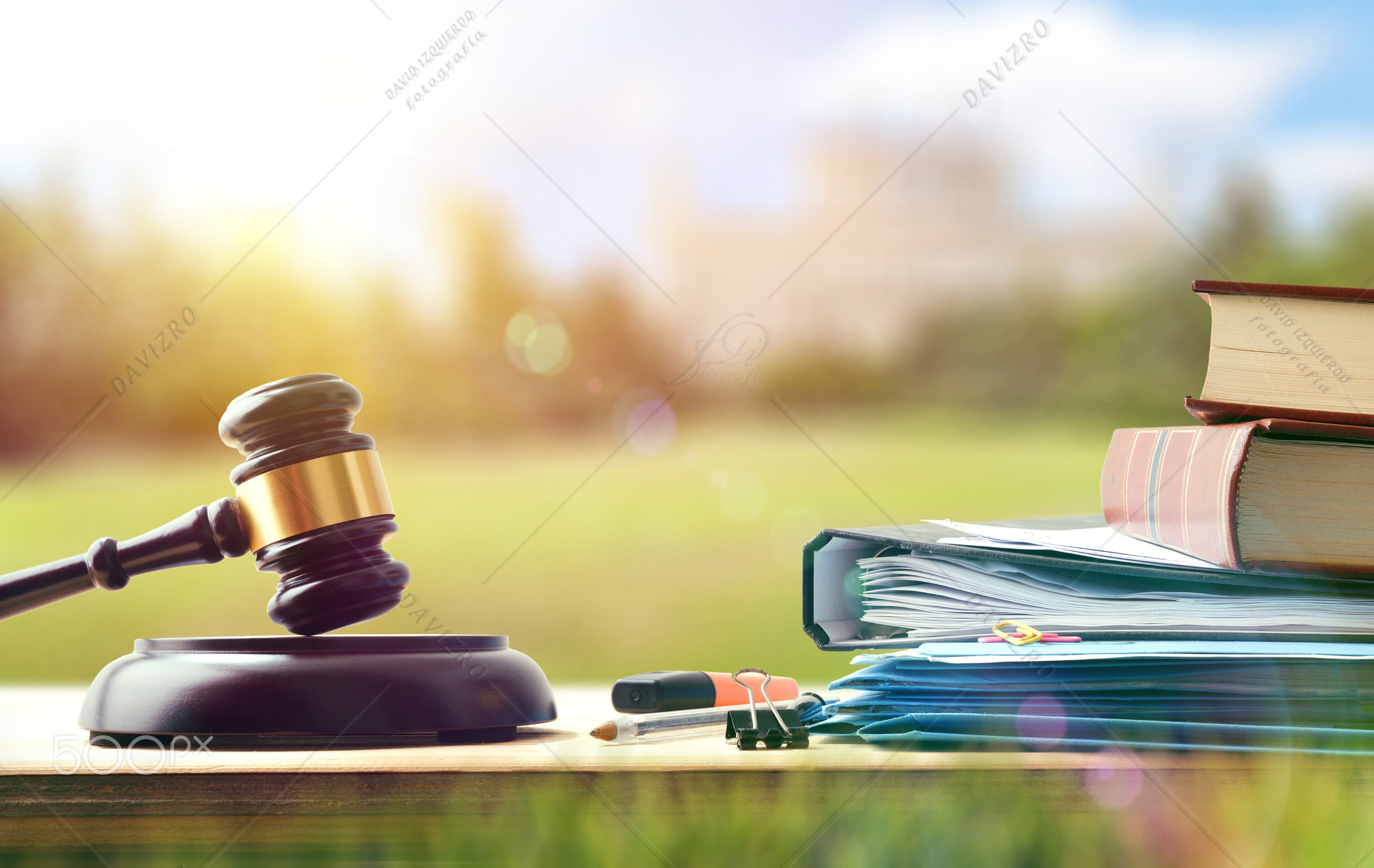 Law study material on wooden bench in college campus