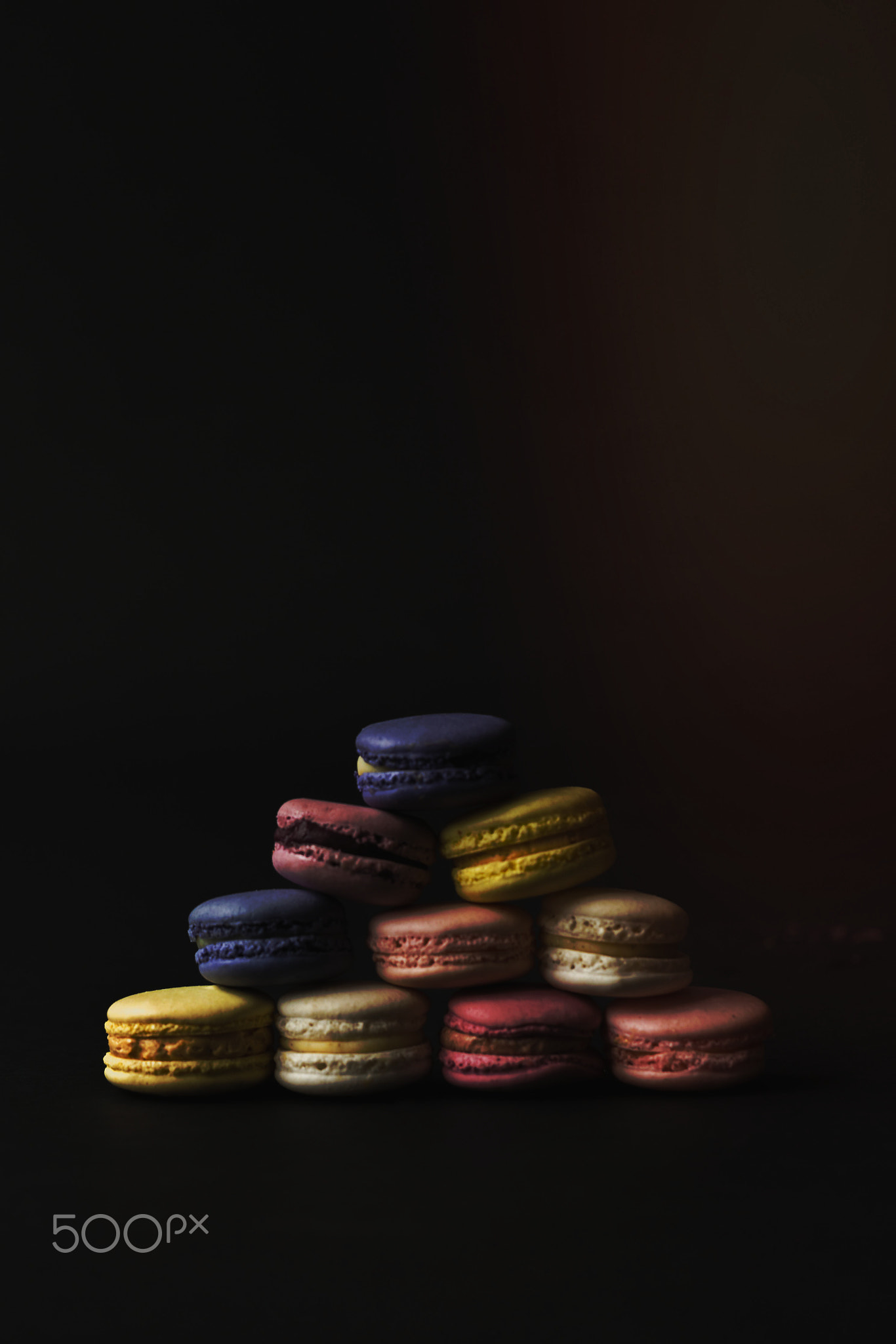 a dark and moody macaron pyramid