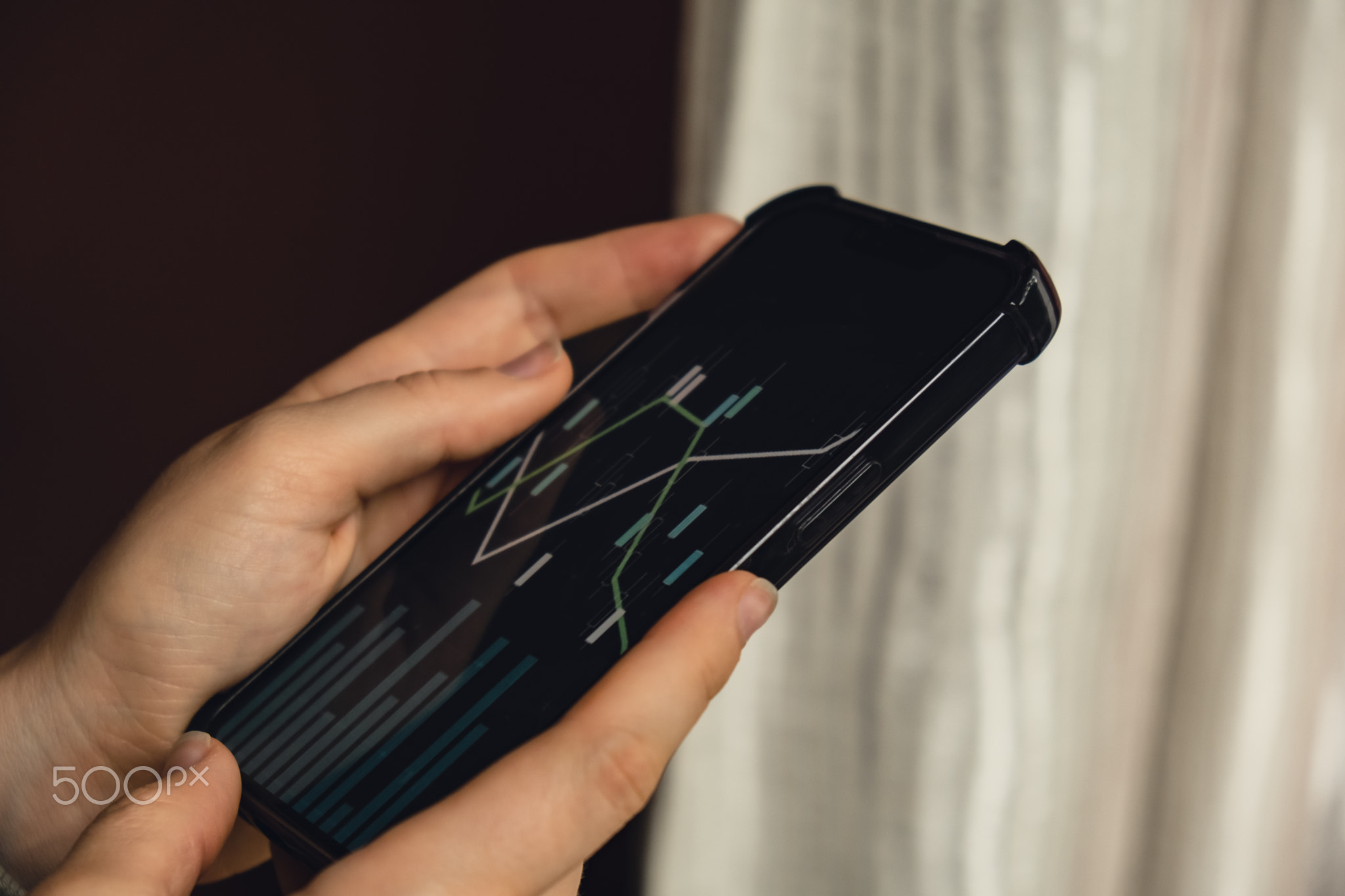 Female hands holding phone, checking Stock market graph for tranding