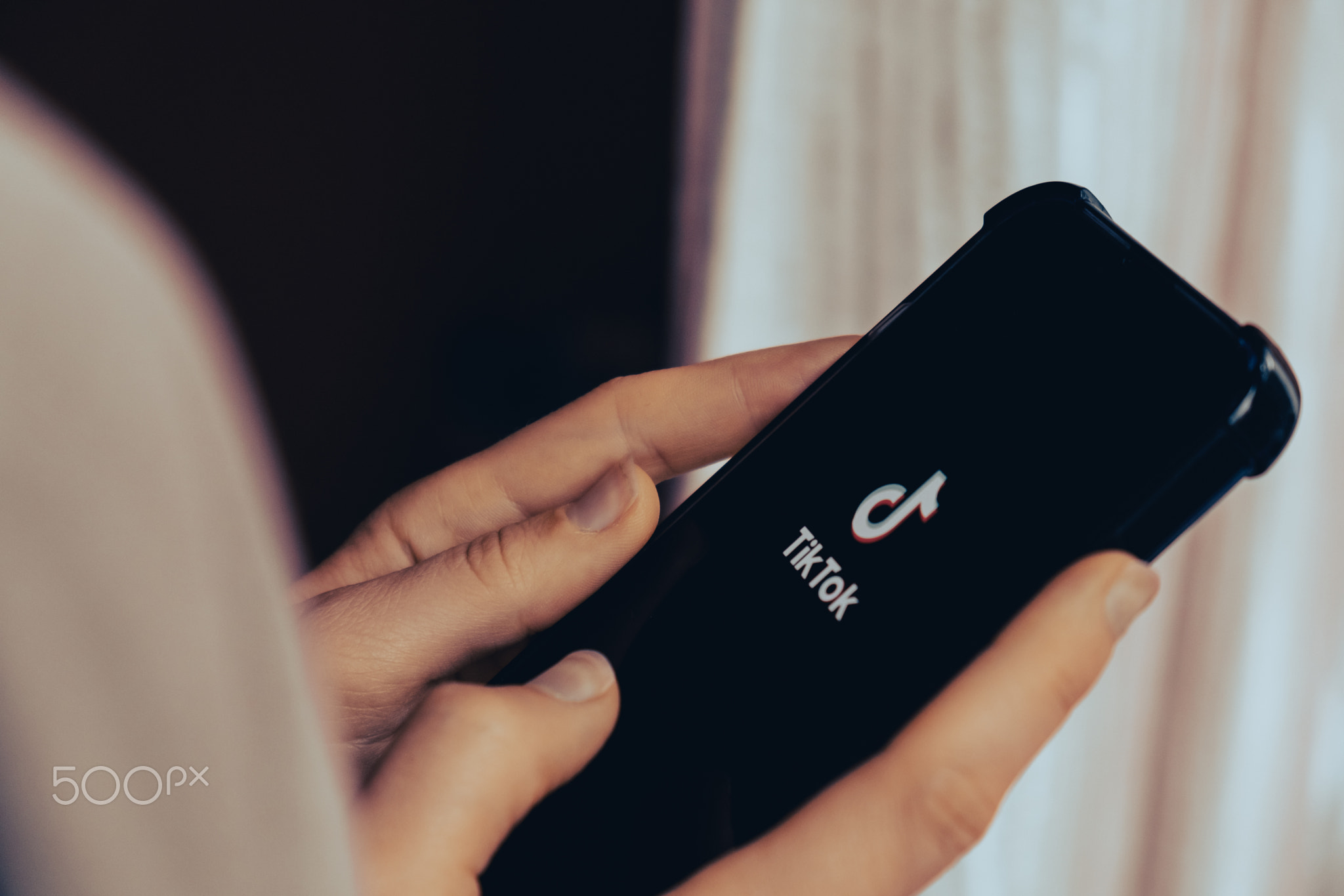 Gdansk, Poland - June 2022: female hand scrolling social media feed on