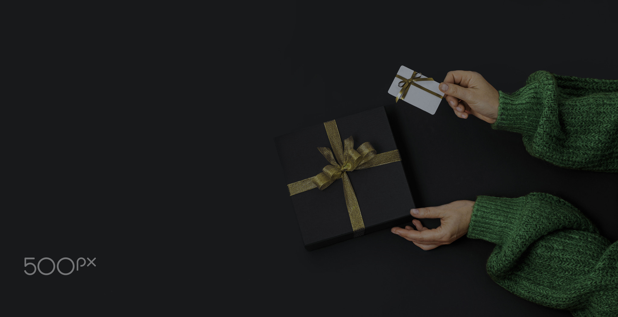 Black Friday Concept. top view photo of hands holding Black gift box