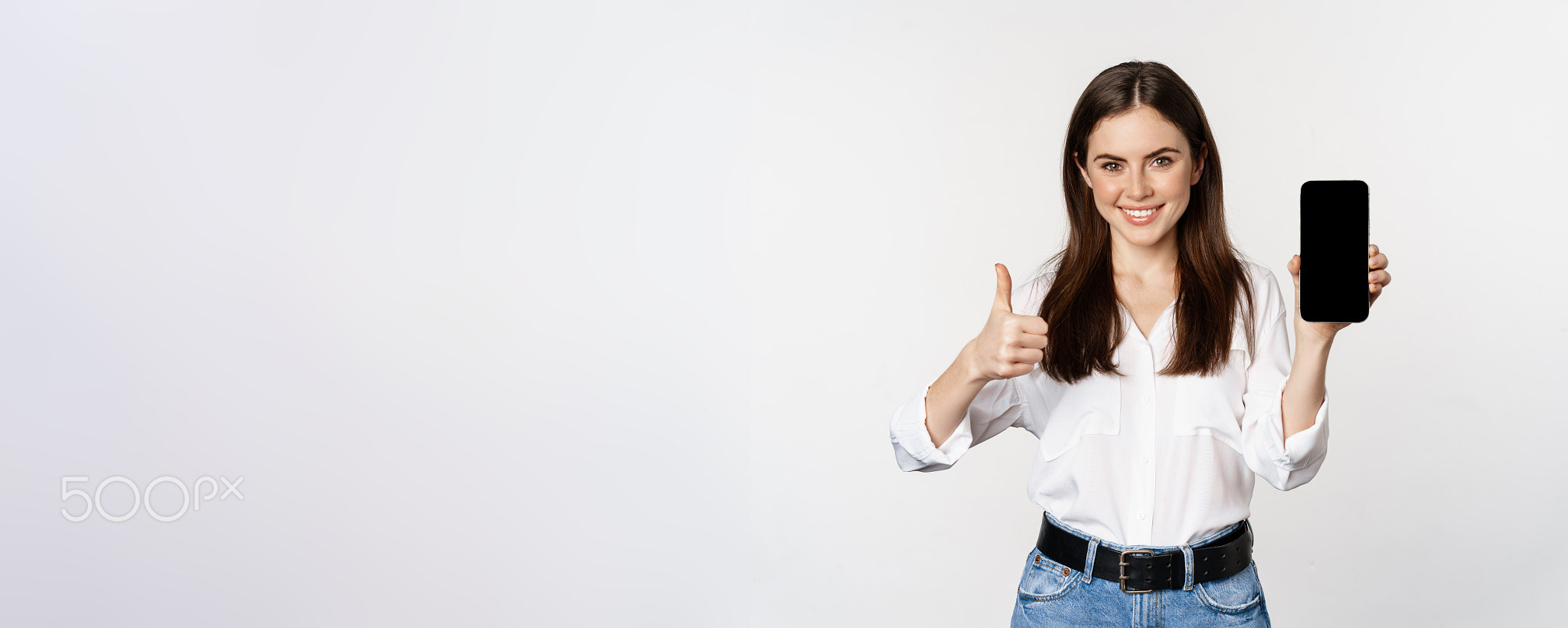 Smiling woman showing thumbs up, recommending app, mobile phone screen