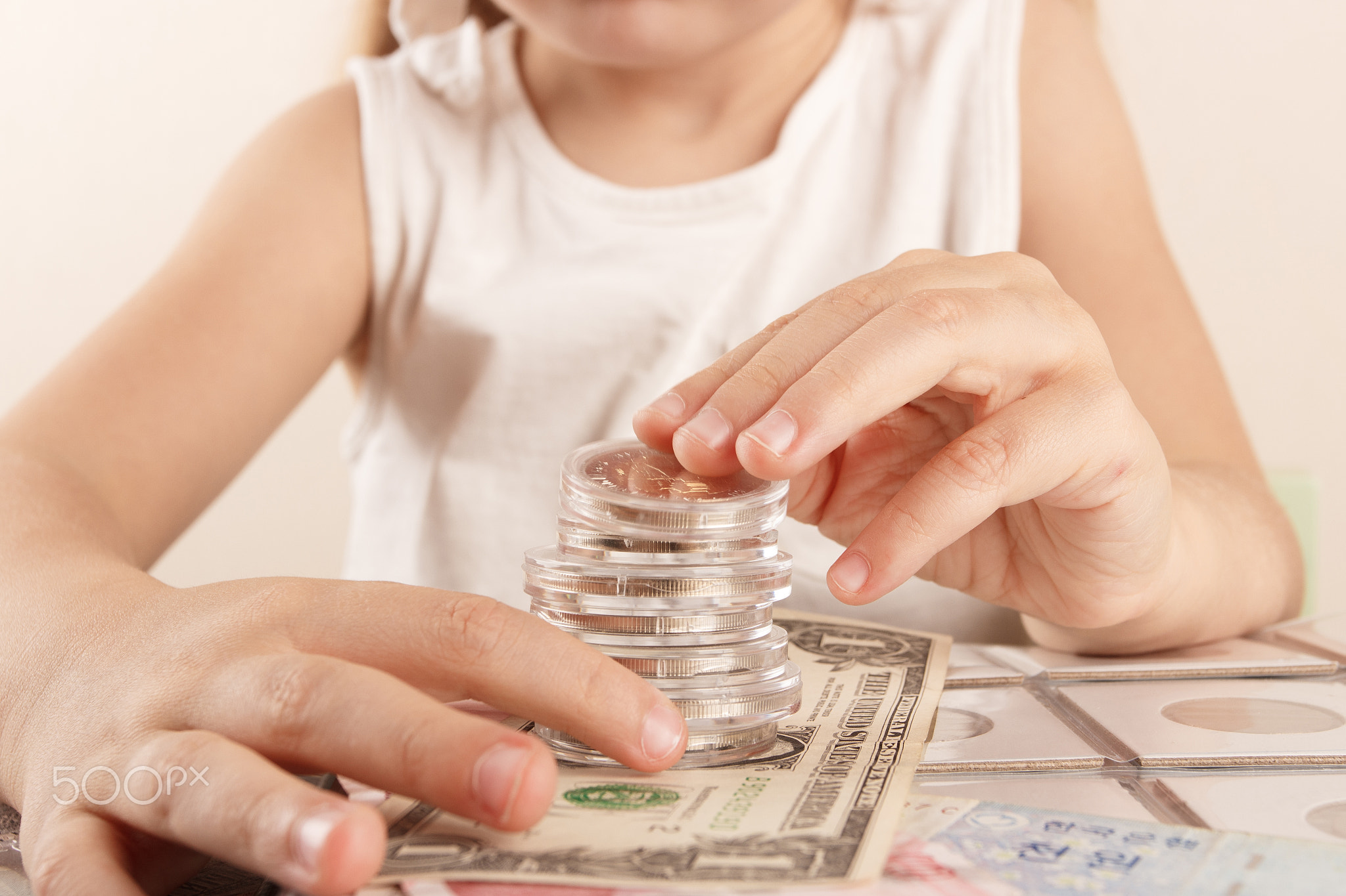 Child with different coins and banknotes