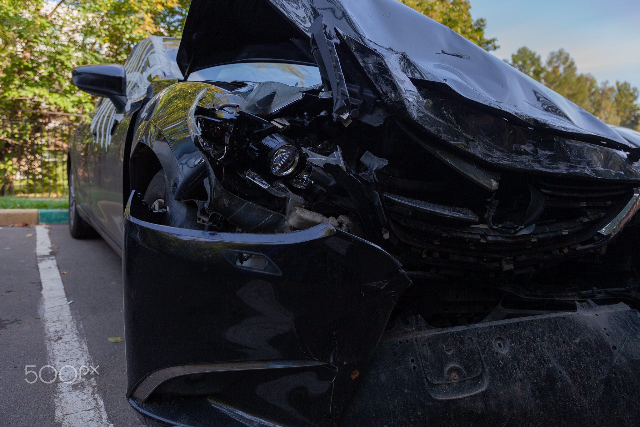 A car damaged in an accident is parked