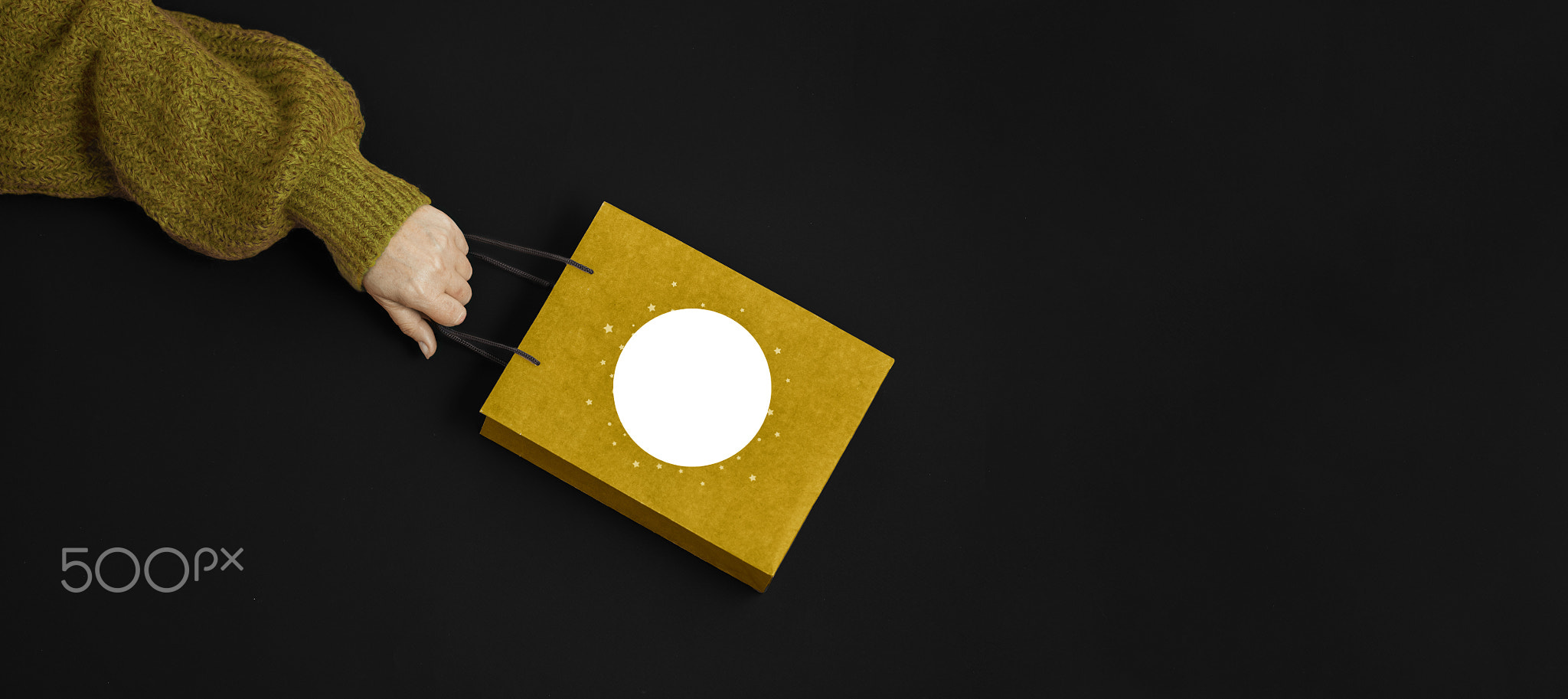 Female hands holding gift kraft bag. woman running to get the latest