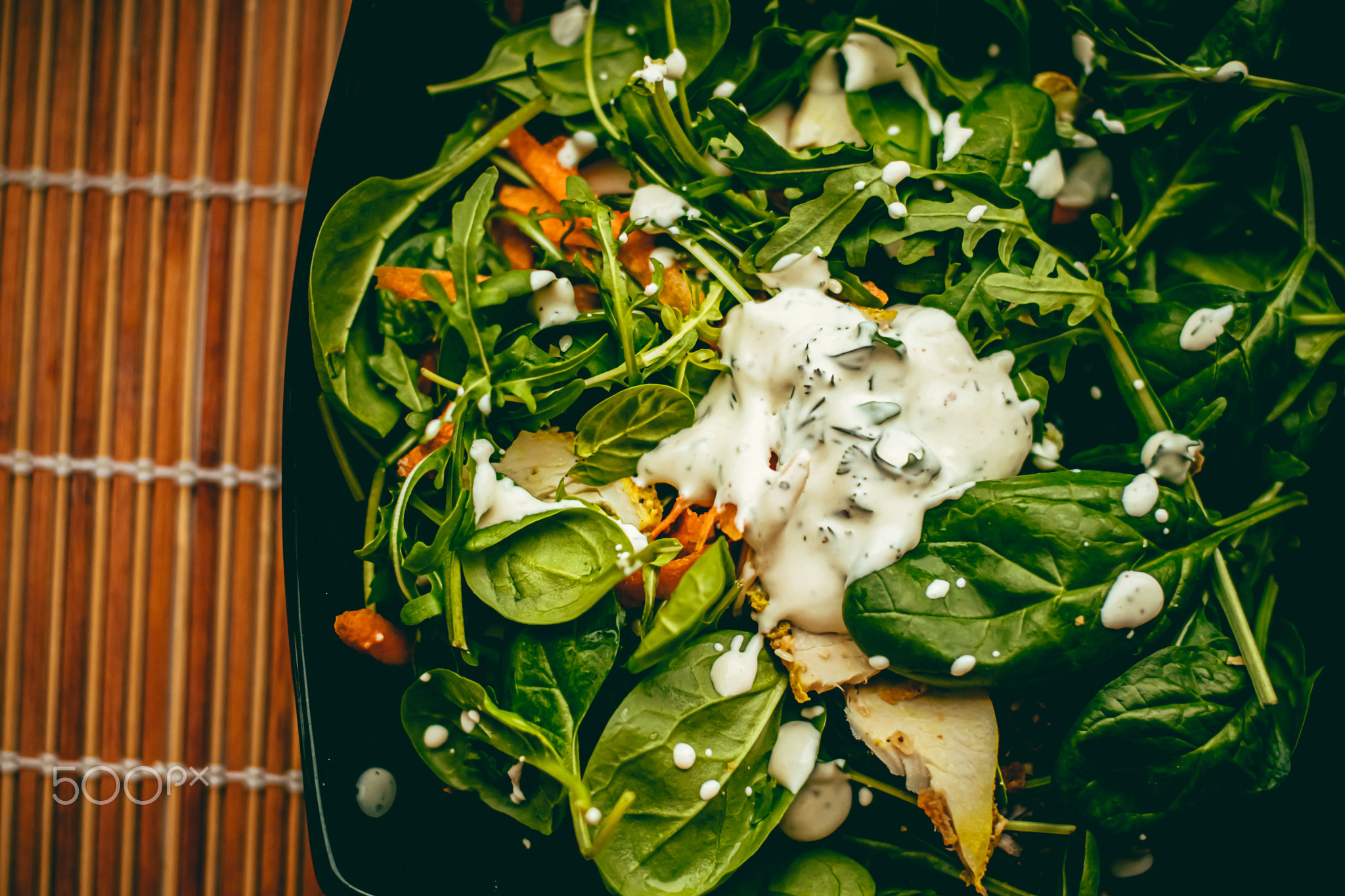 Green salad with basil and white garlic cream sauce for healthy diet