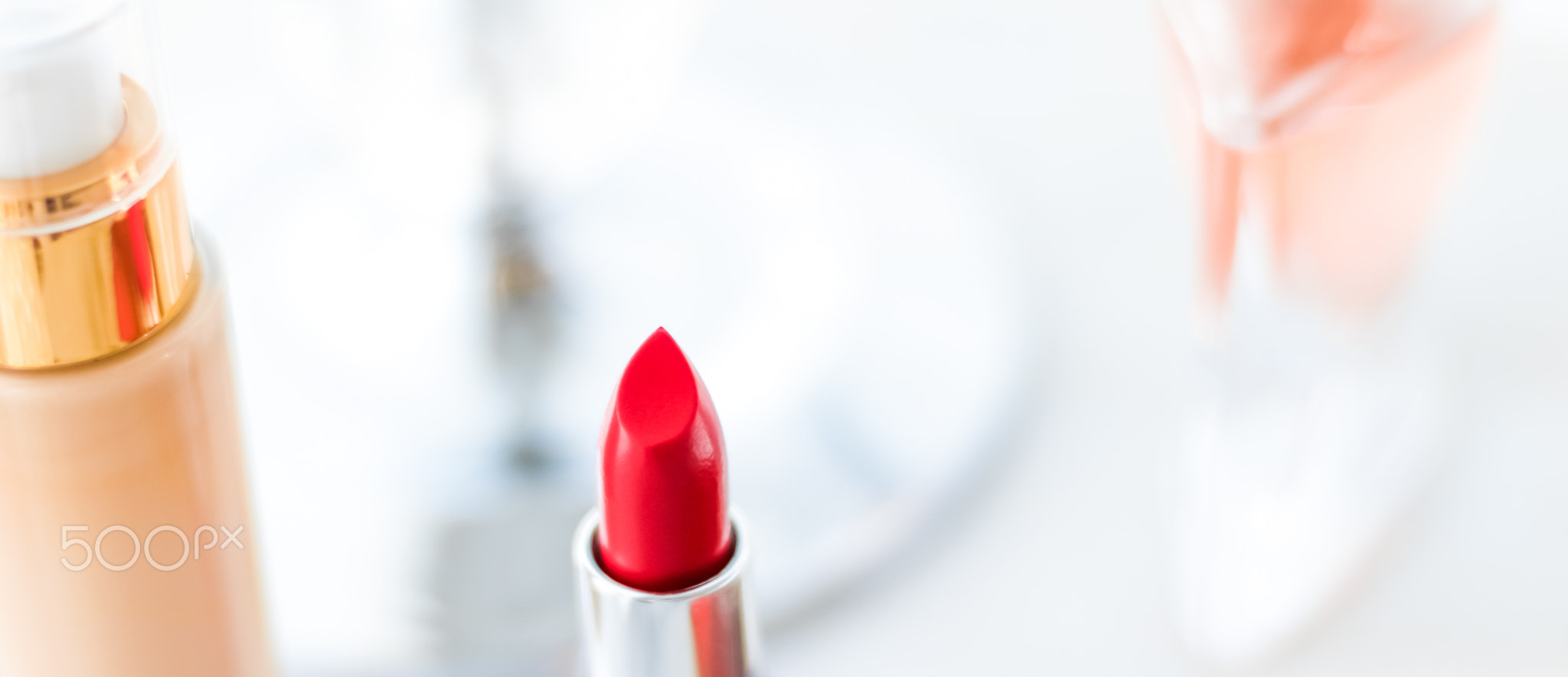 Cosmetics, makeup products on dressing vanity table, lipstick