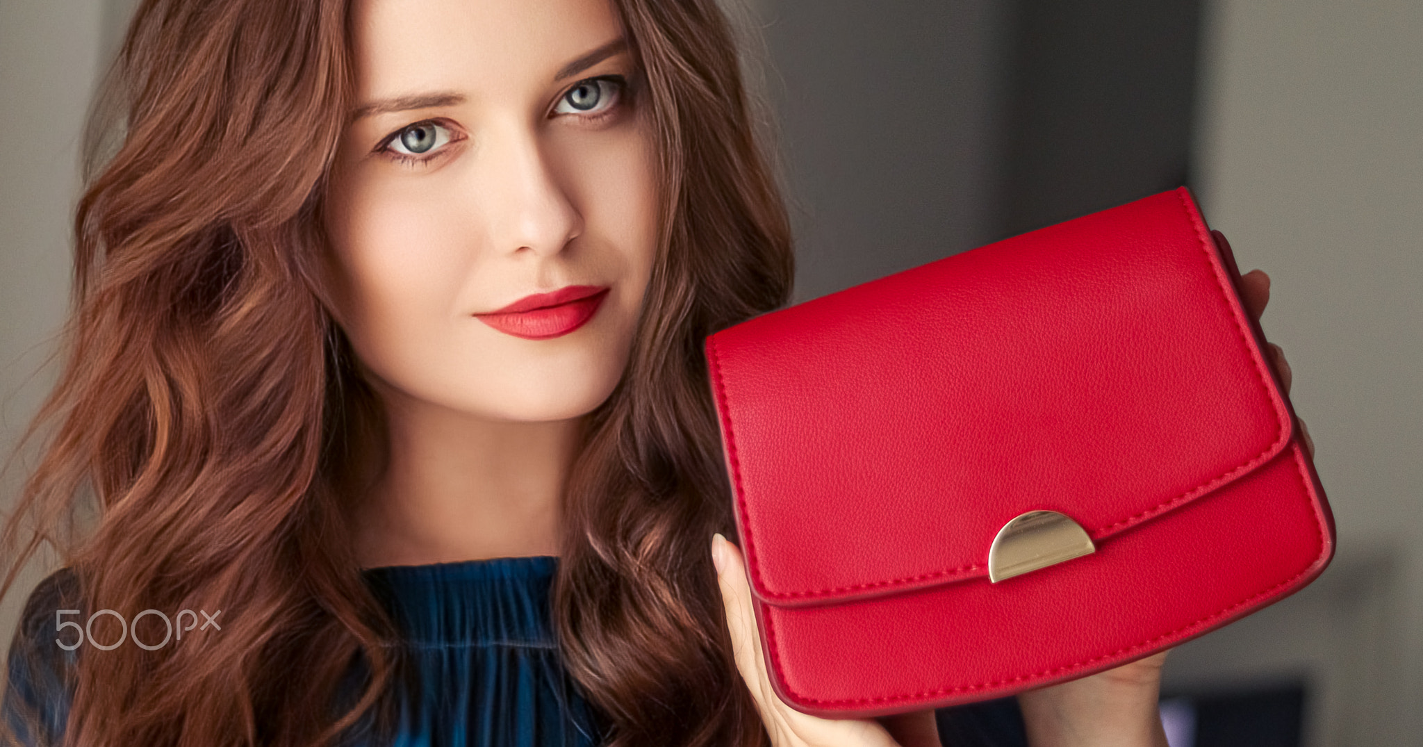 Fashion and accessories, happy beautiful woman holding small red