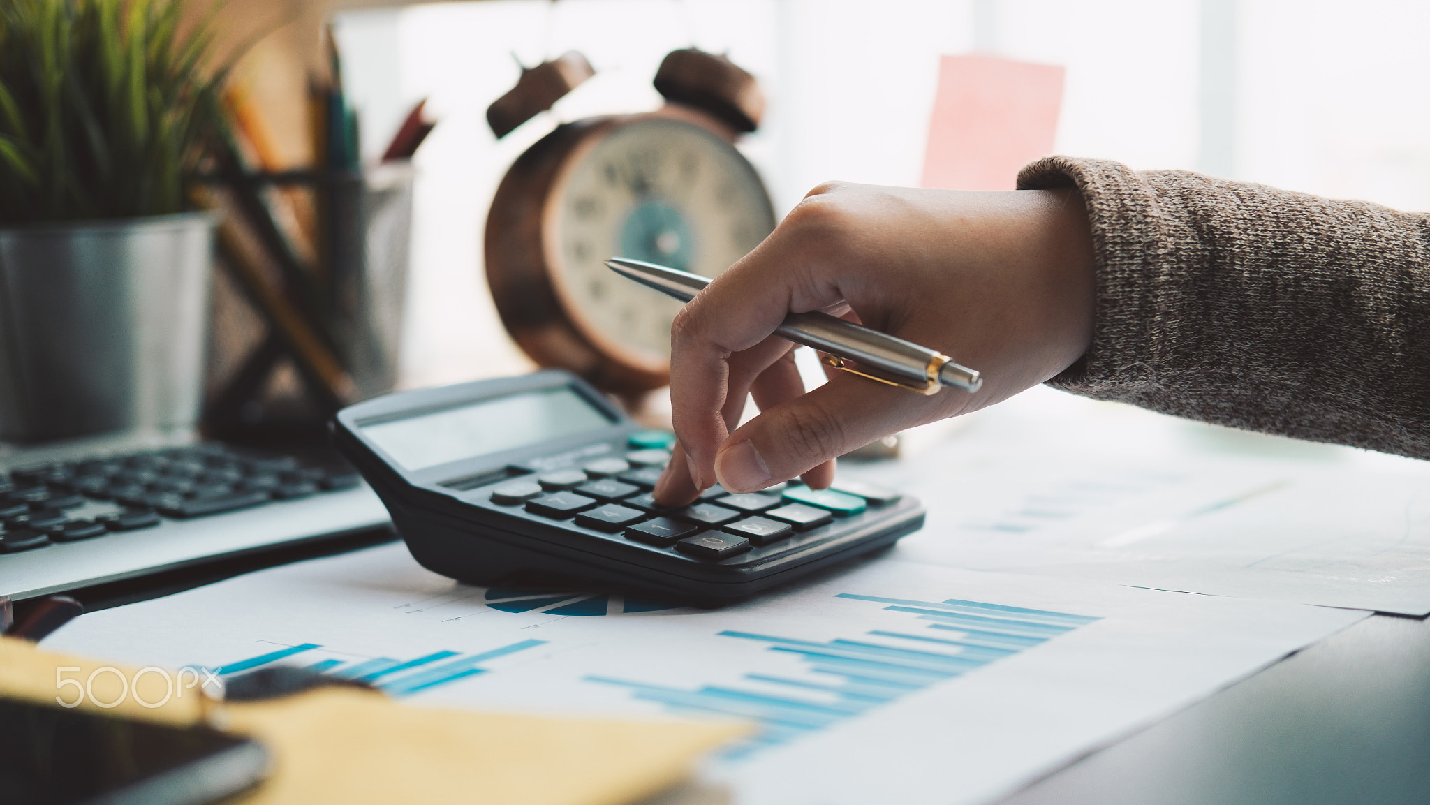 Business woman working in finance with calculator and accounting