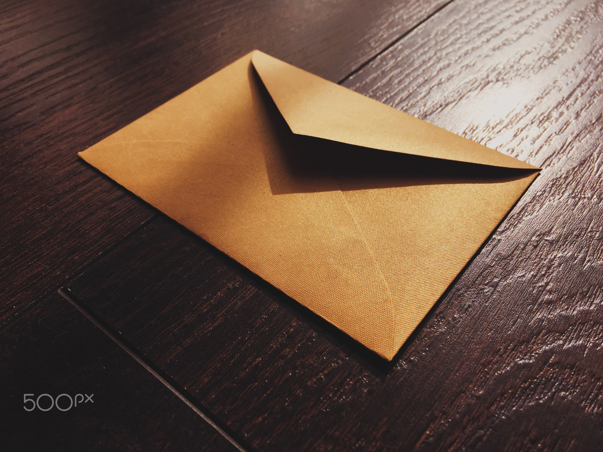 Golden vintage envelope on wooden background, newsletter and message