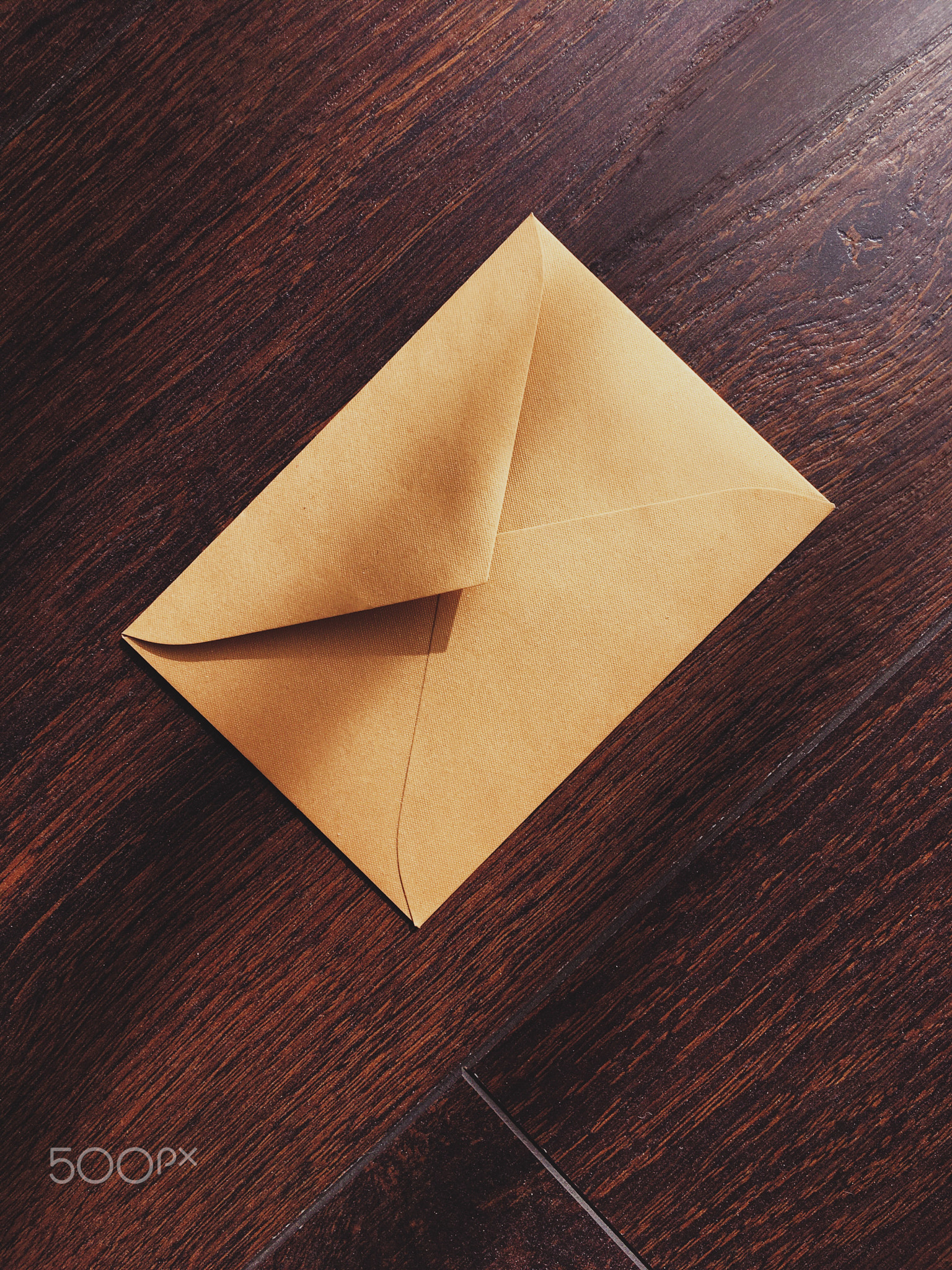 Golden vintage envelope on wooden background, newsletter and message