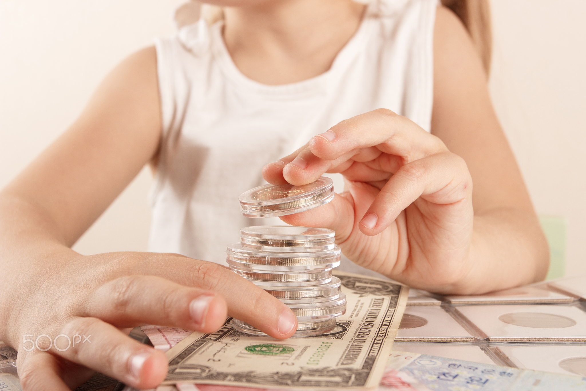 Child with different coins and banknotes