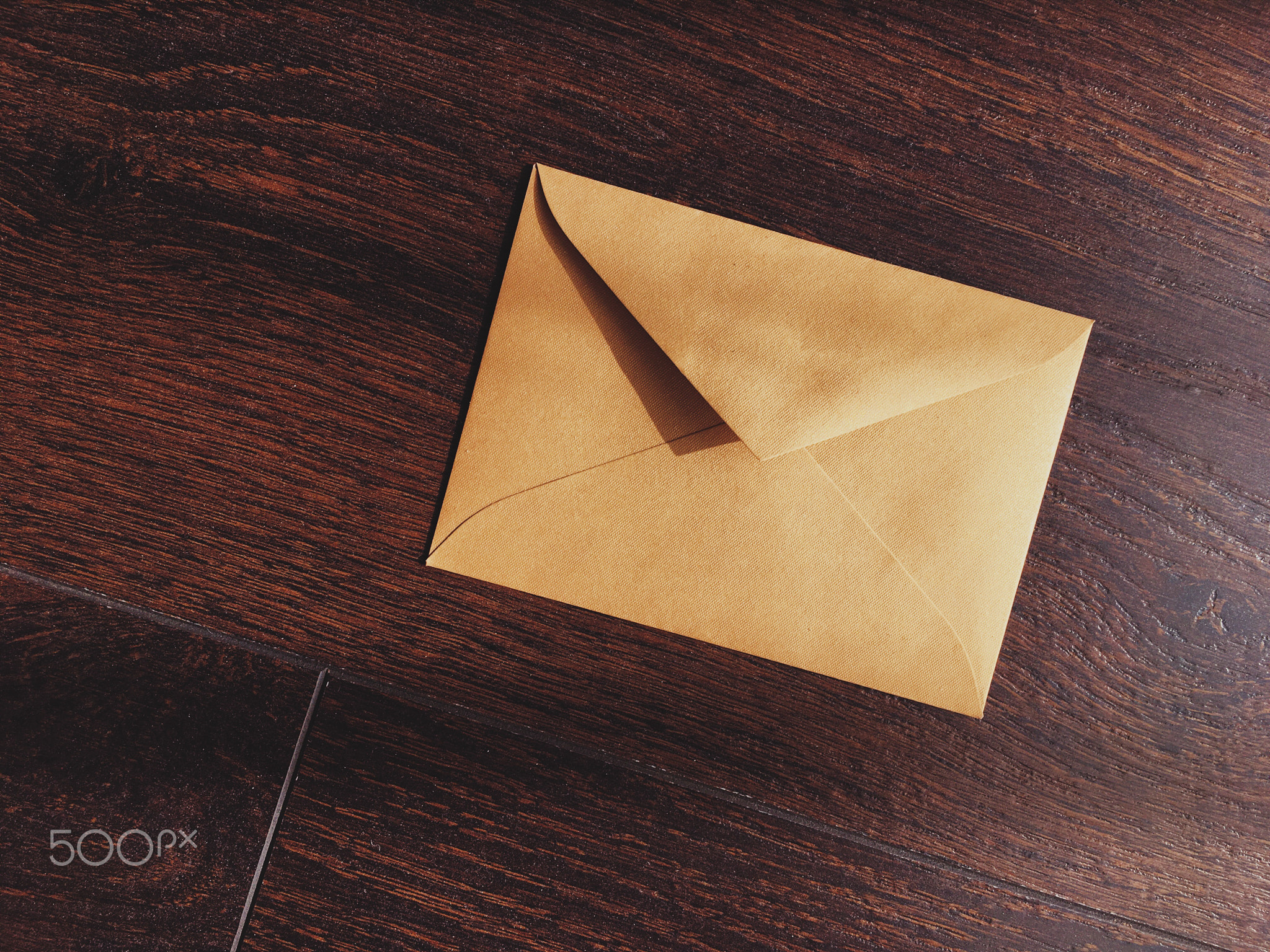 Golden vintage envelope on wooden background, newsletter and message