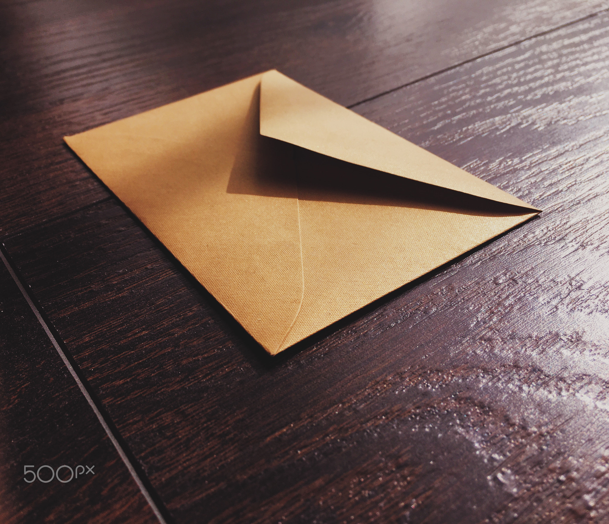 Golden vintage envelope on wooden background, newsletter and message