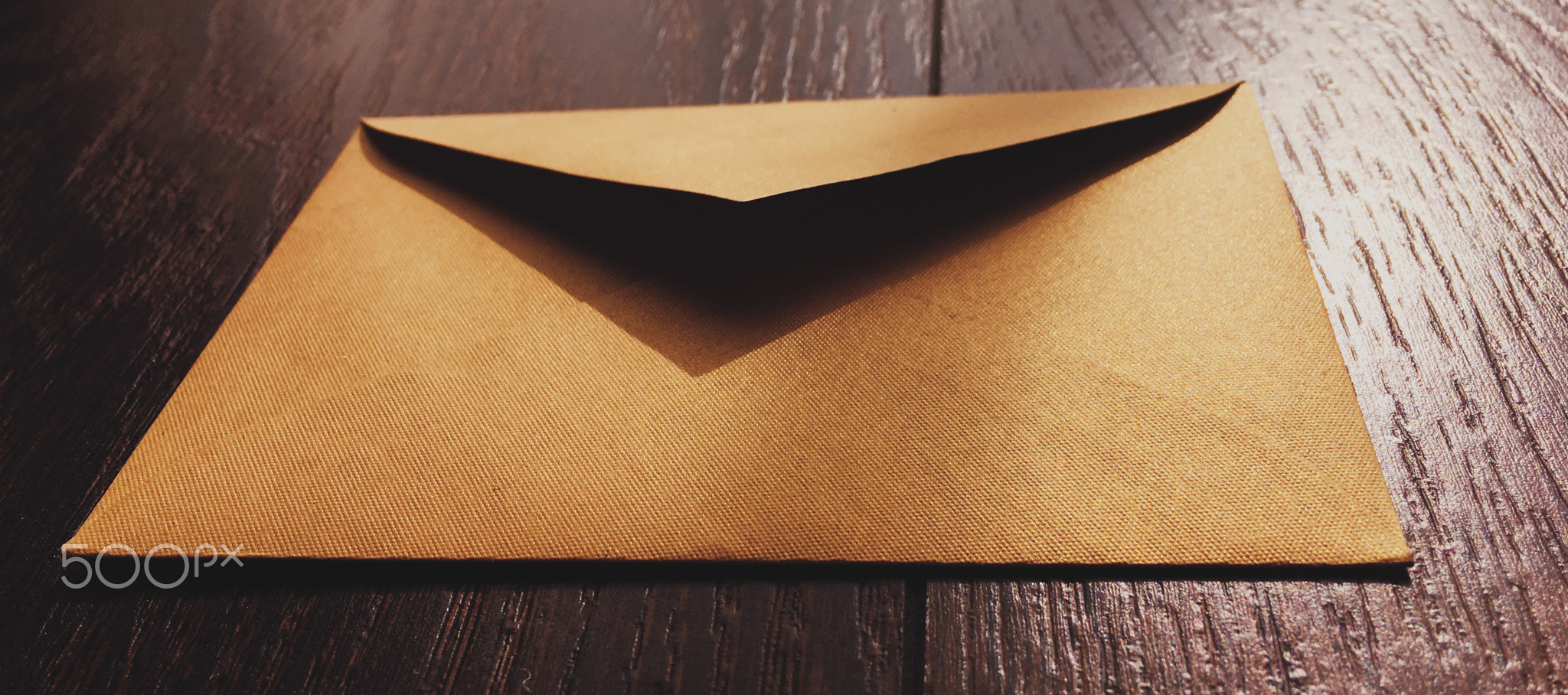 Golden vintage envelope on wooden background, newsletter and message