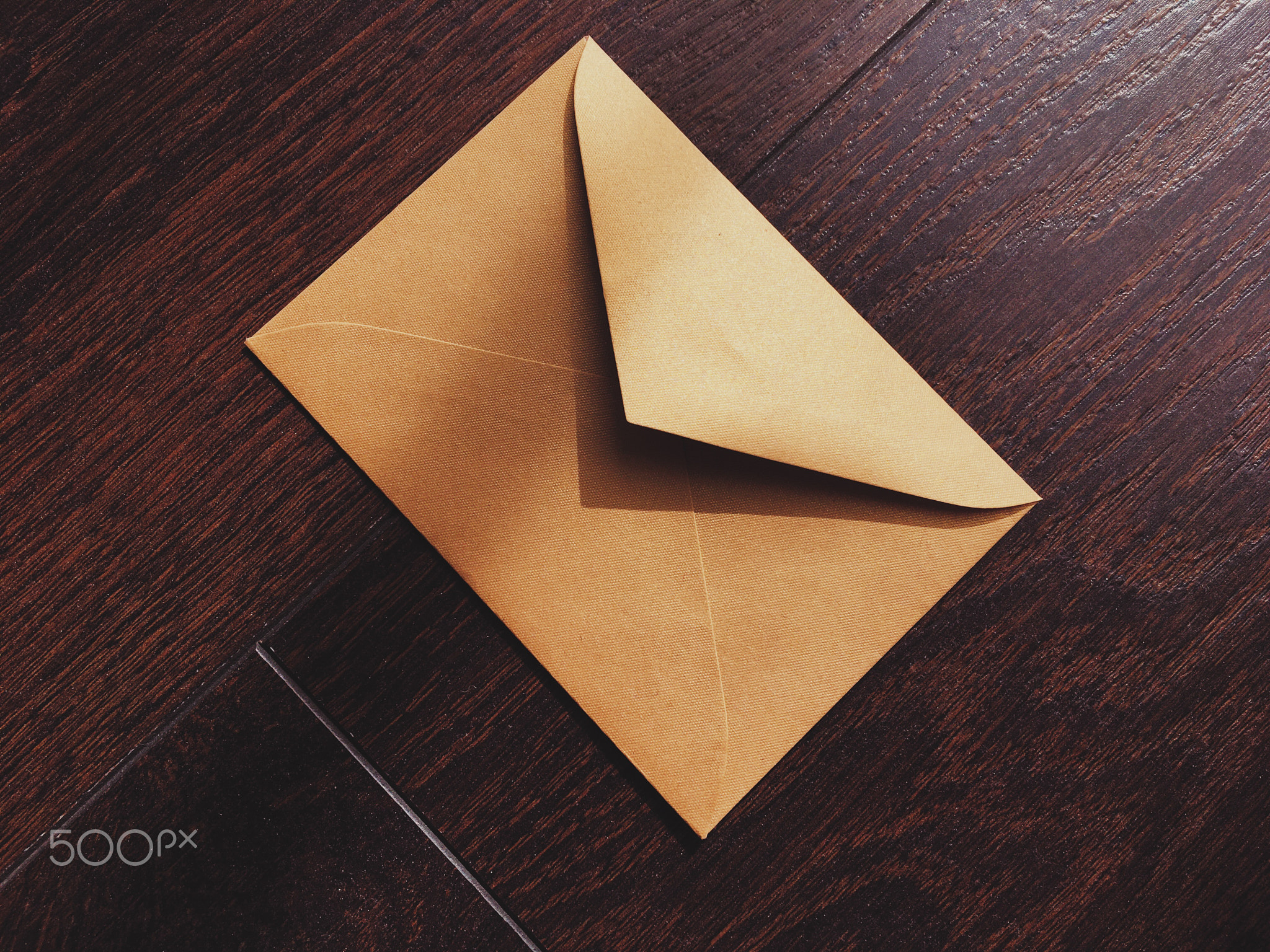 Golden vintage envelope on wooden background, newsletter and message